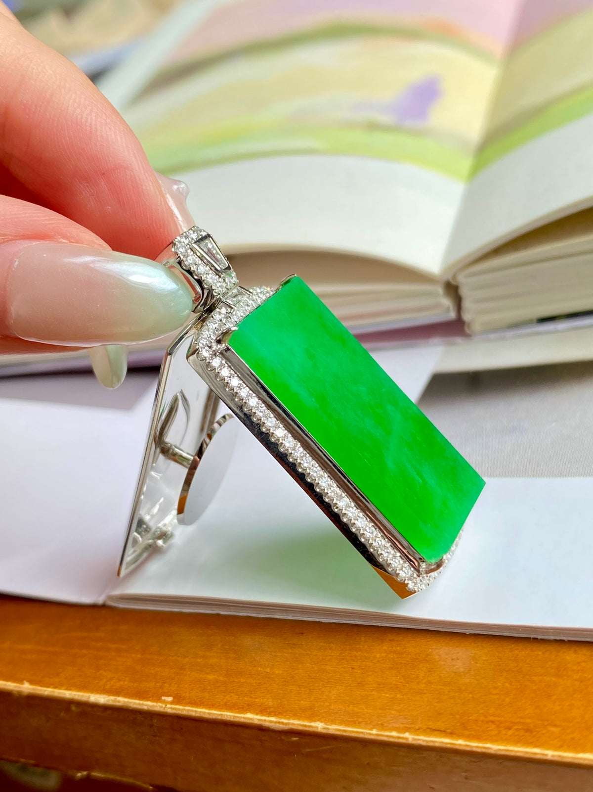 Green jadeite tablet pendant with silver side setting and diamond-like pave border