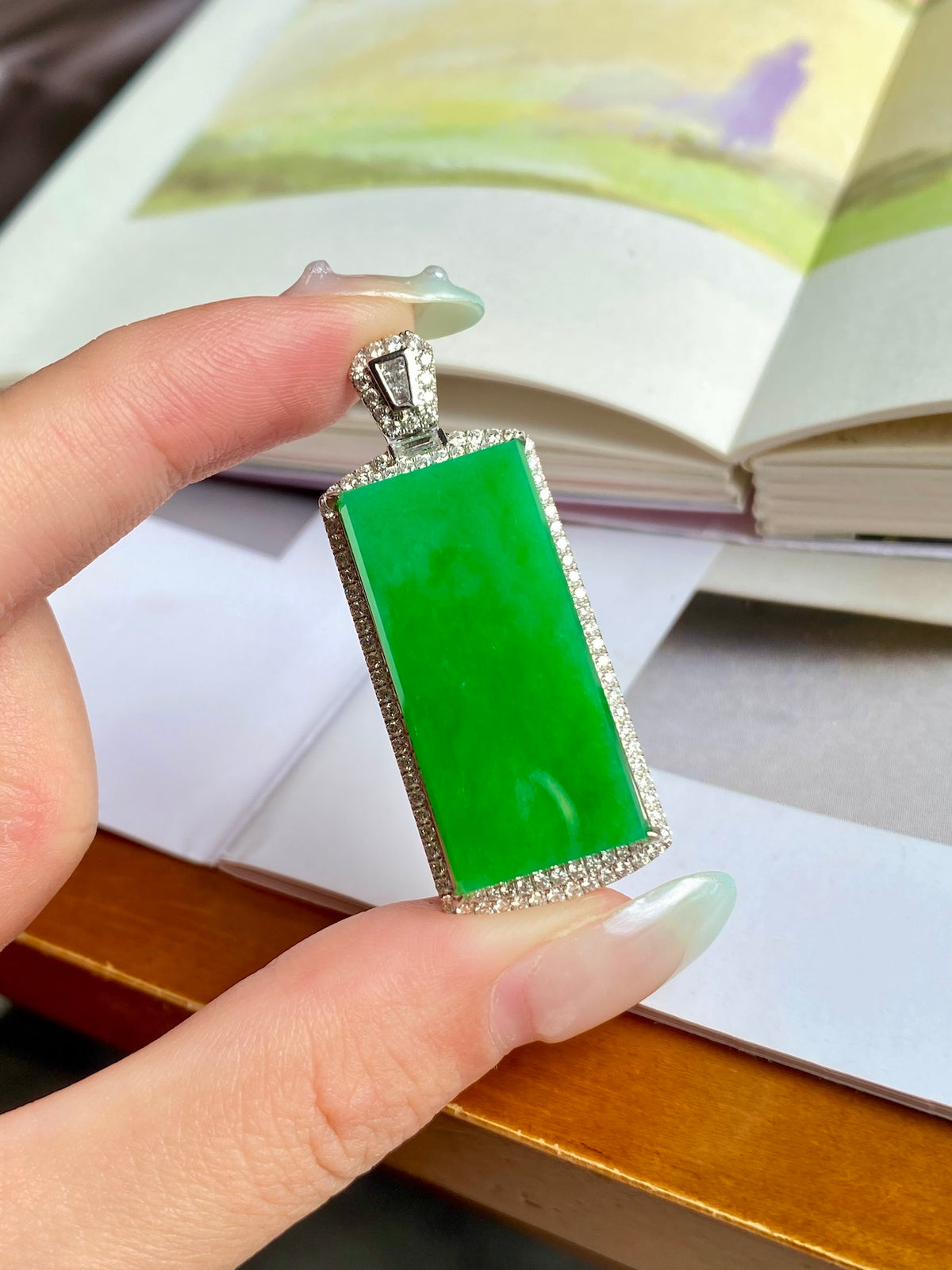Green jadeite tablet pendant with silver frame and diamond-like accent stones