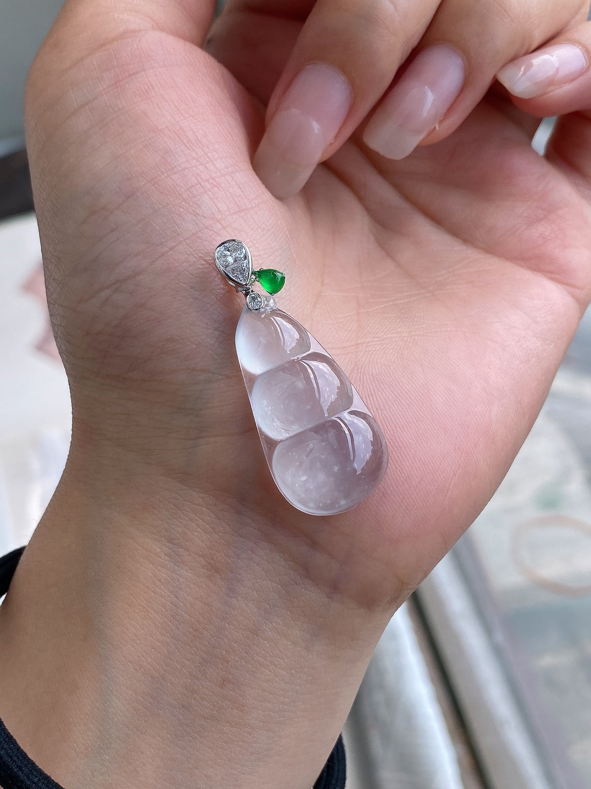 White jadeite pea pod pendant with green stone accent and small round sparkle top