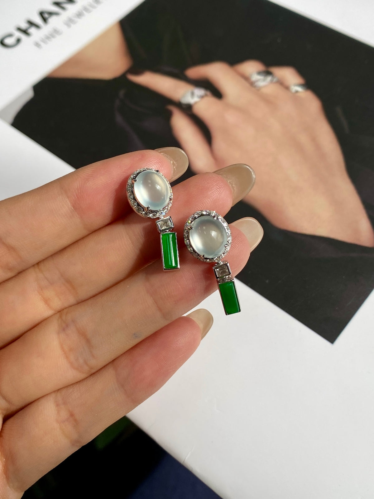 Silver-tone stud earrings with round white cabochon and green baguette drop accents