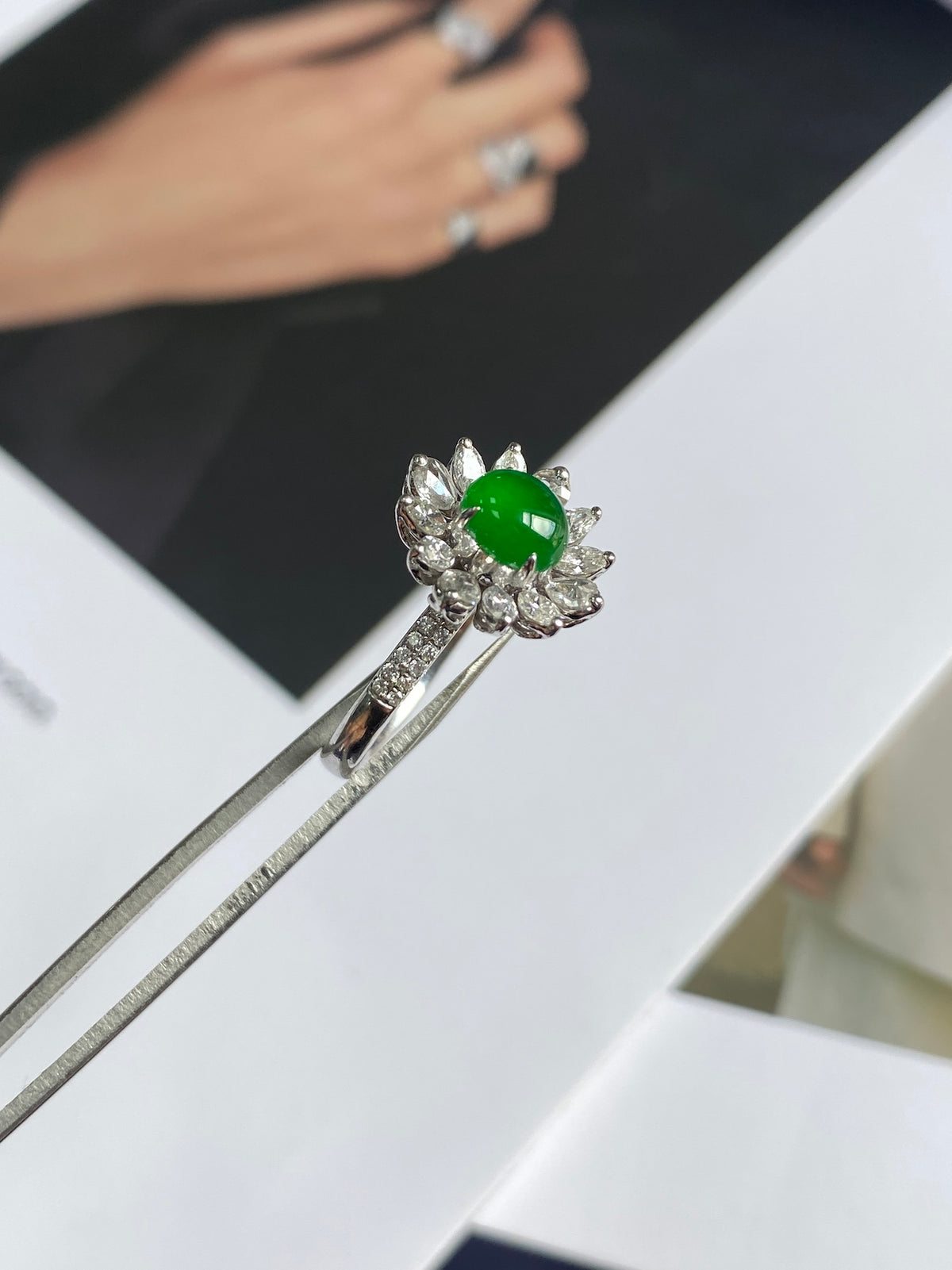 Silver jadeite cabochon ring featuring a green round center and starburst stones