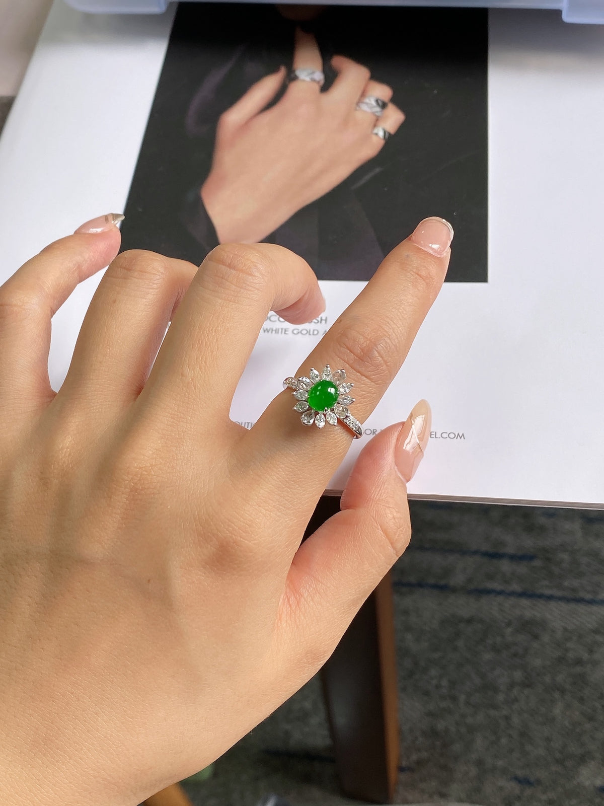 Silver ring with green jadeite cabochon and diamond-like flower halo