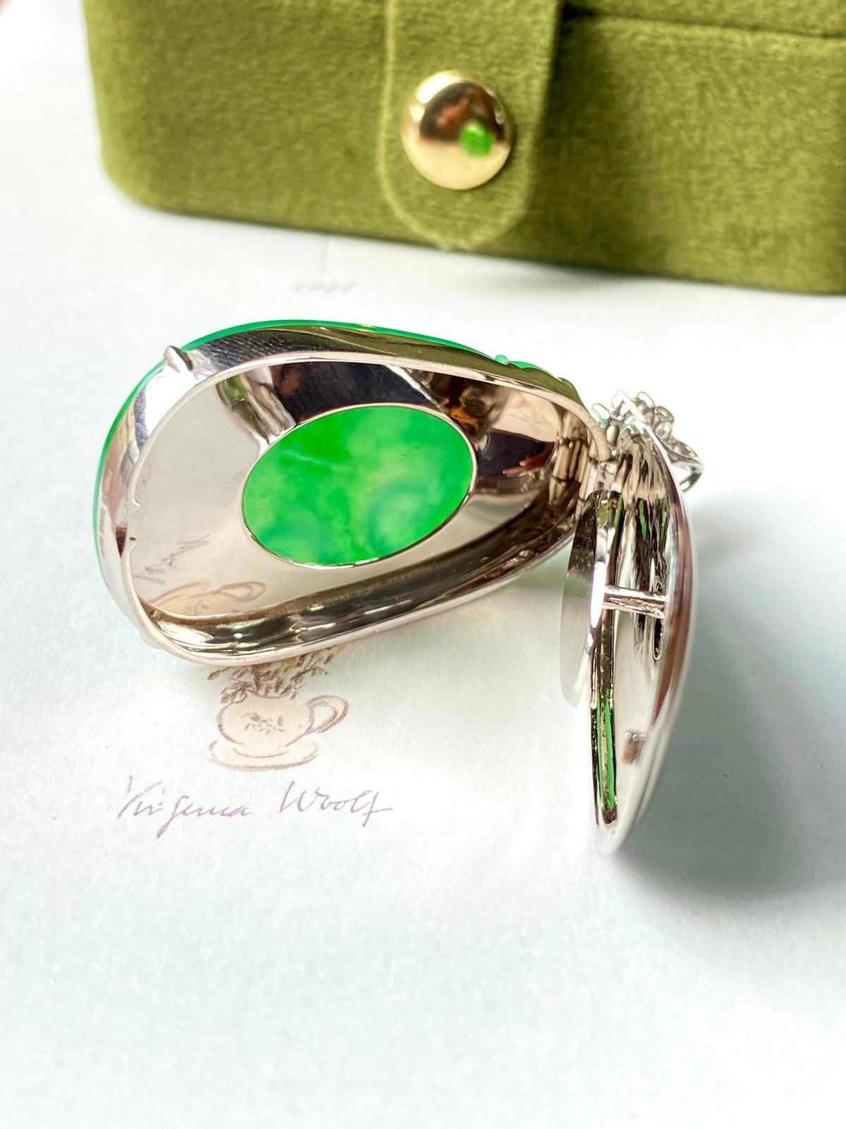 Silver ring setting with green jadeite cabochon inset and diamond-accent bail loop