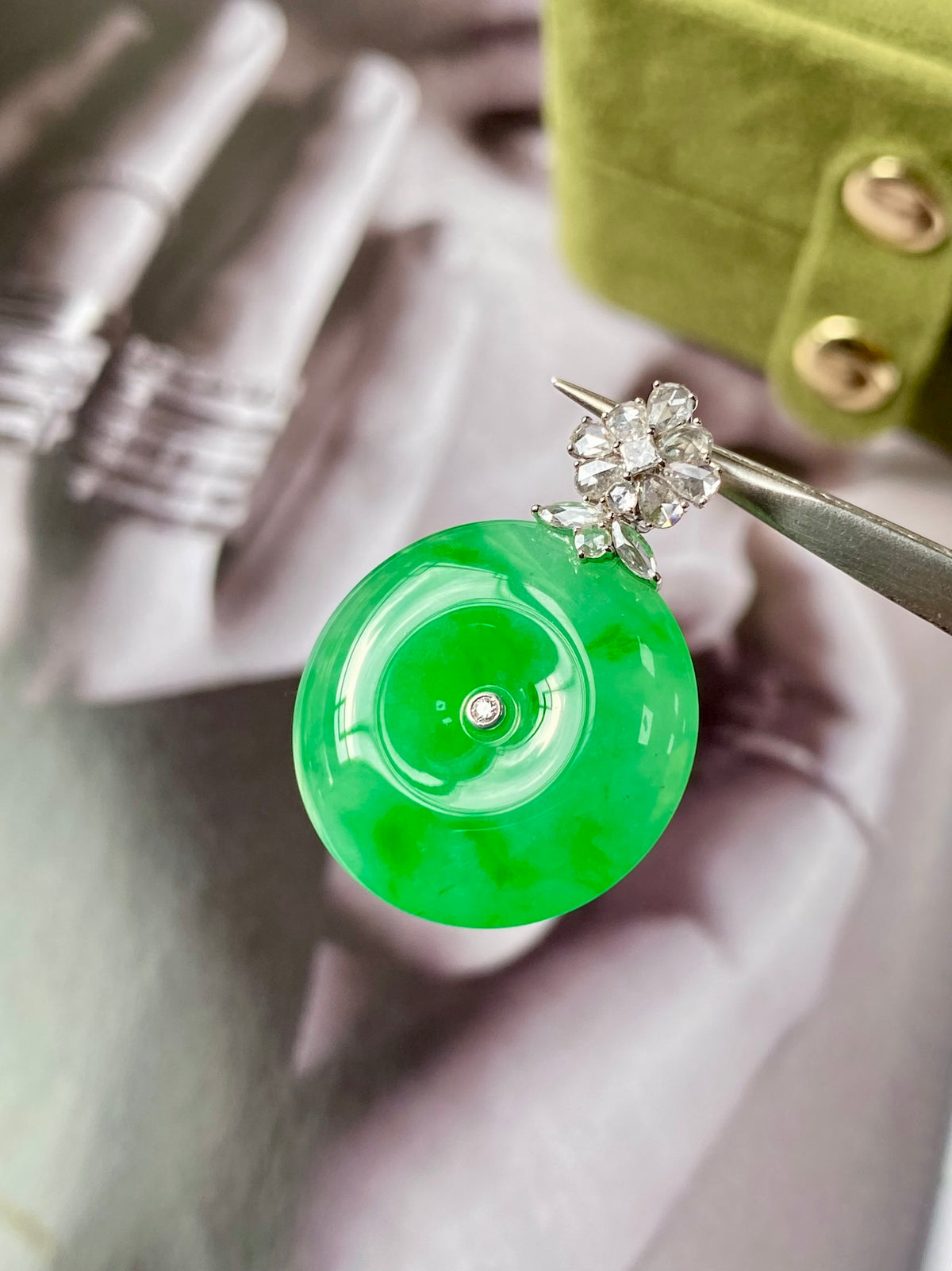 Green jadeite donut pendant close-up with silver bail and flower-like diamond cluster