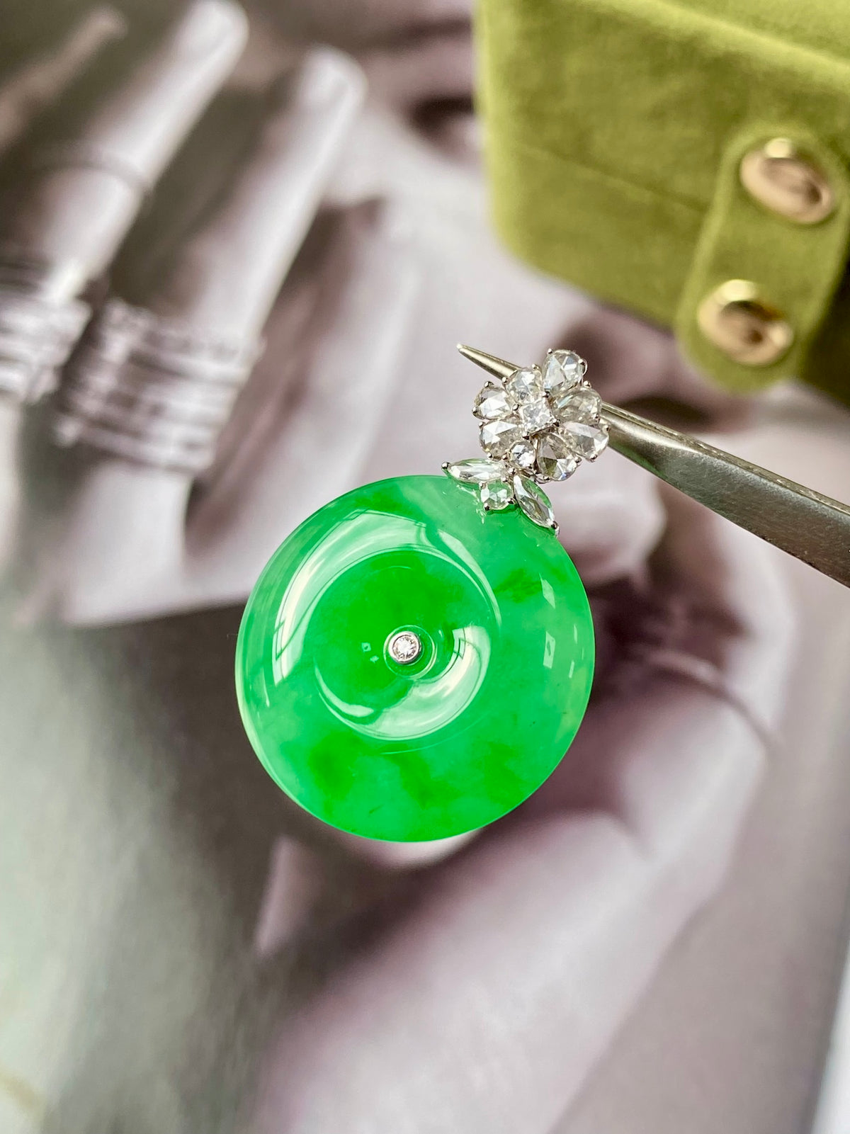 Green jadeite donut pendant with silver top setting and clustered sparkling stones
