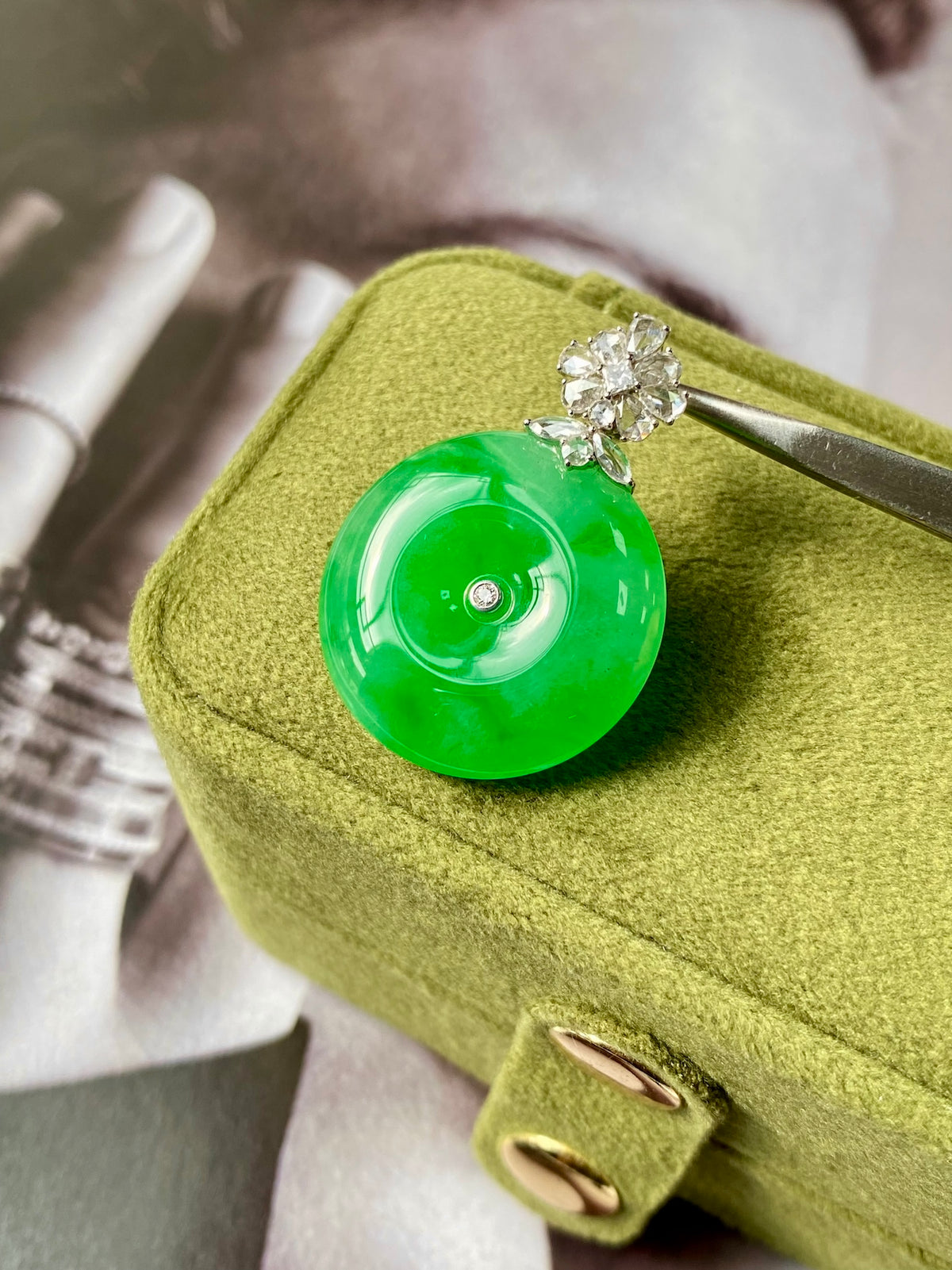 Green jadeite donut pendant in gold/green box with silver bail and diamond cluster top