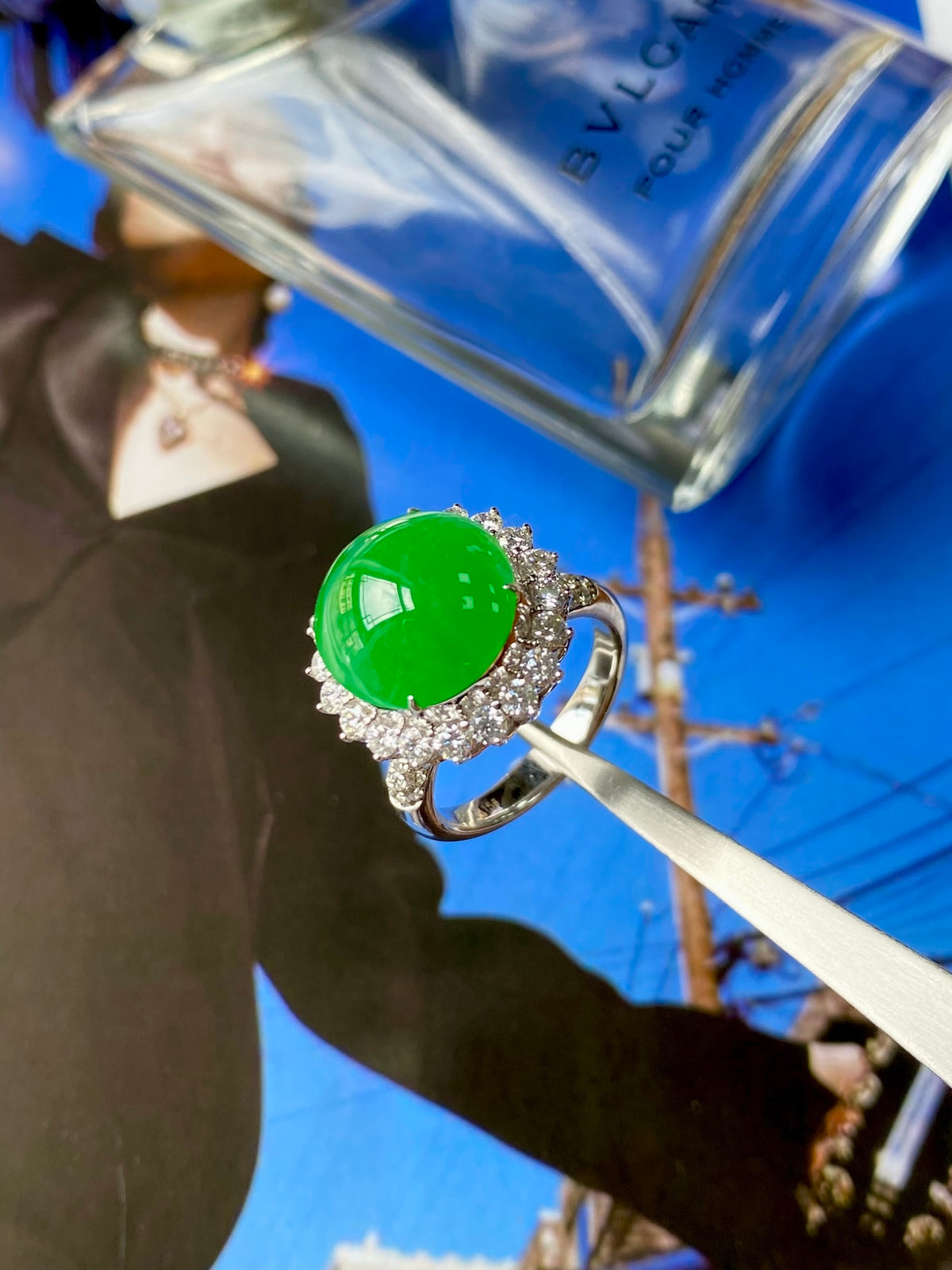 Green jadeite cabochon ring with diamond halo and curved metal band