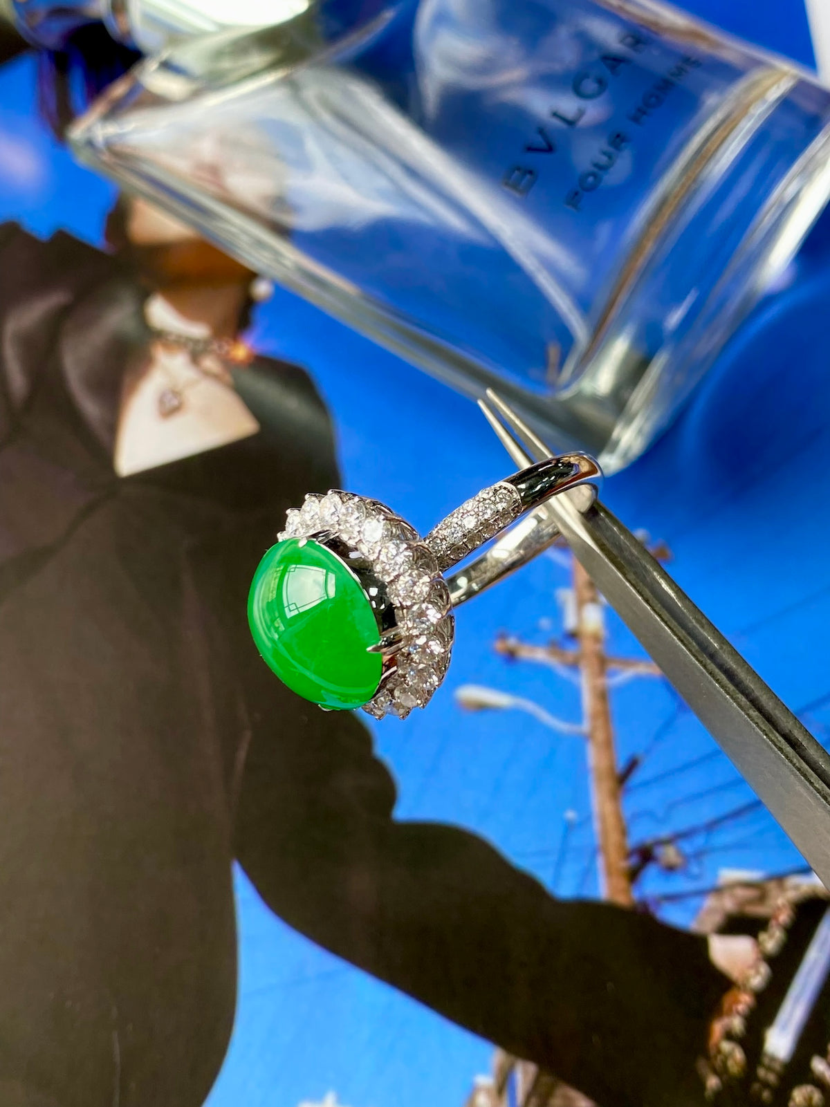 Green jadeite cabochon ring with diamond halo, side profile setting