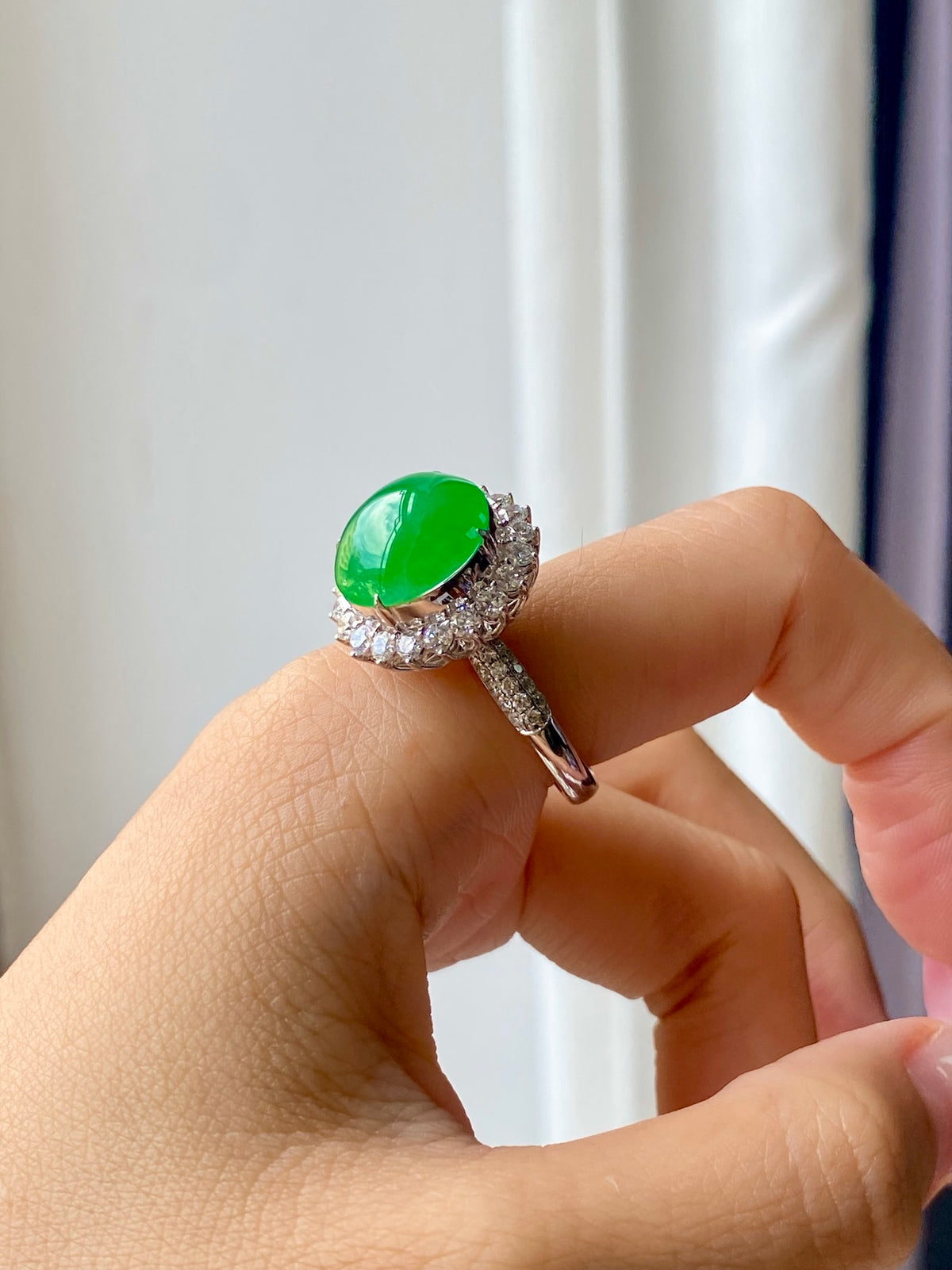 Green jadeite cabochon ring with diamond halo and textured split shank