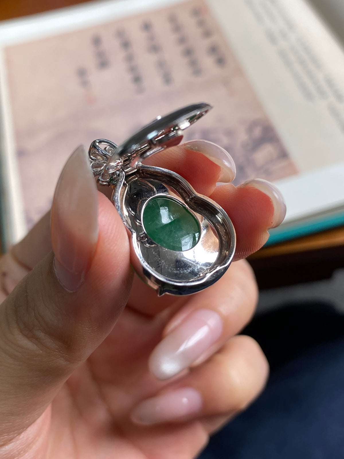 Green gourd jade pendant in silver setting with small round crystal top