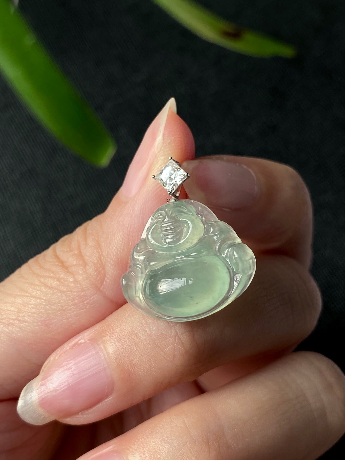 Green jadeite Laughing Buddha pendant with silver setting and small clear top stone