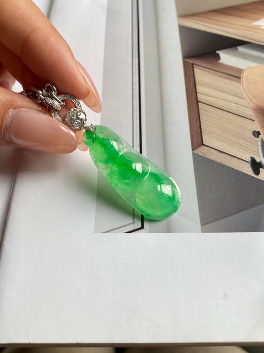 Green jadeite fortune bean pendant with ornate silver-tone clasp