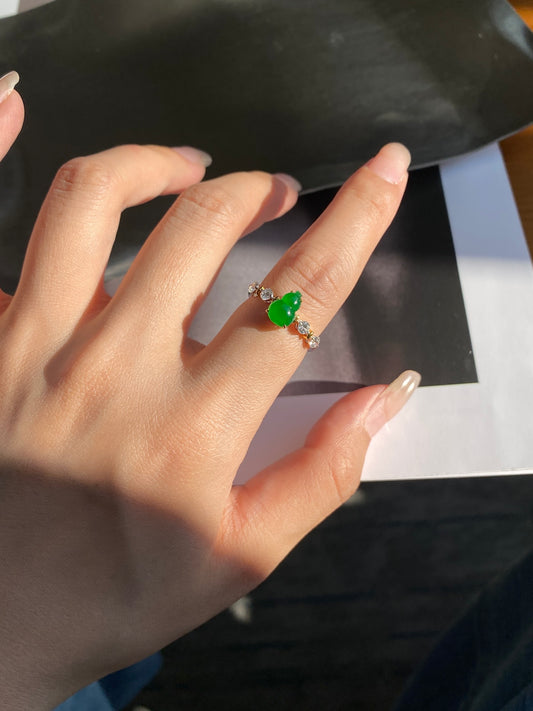 Green jadeite gourd ring with silver band and small clear gemstones