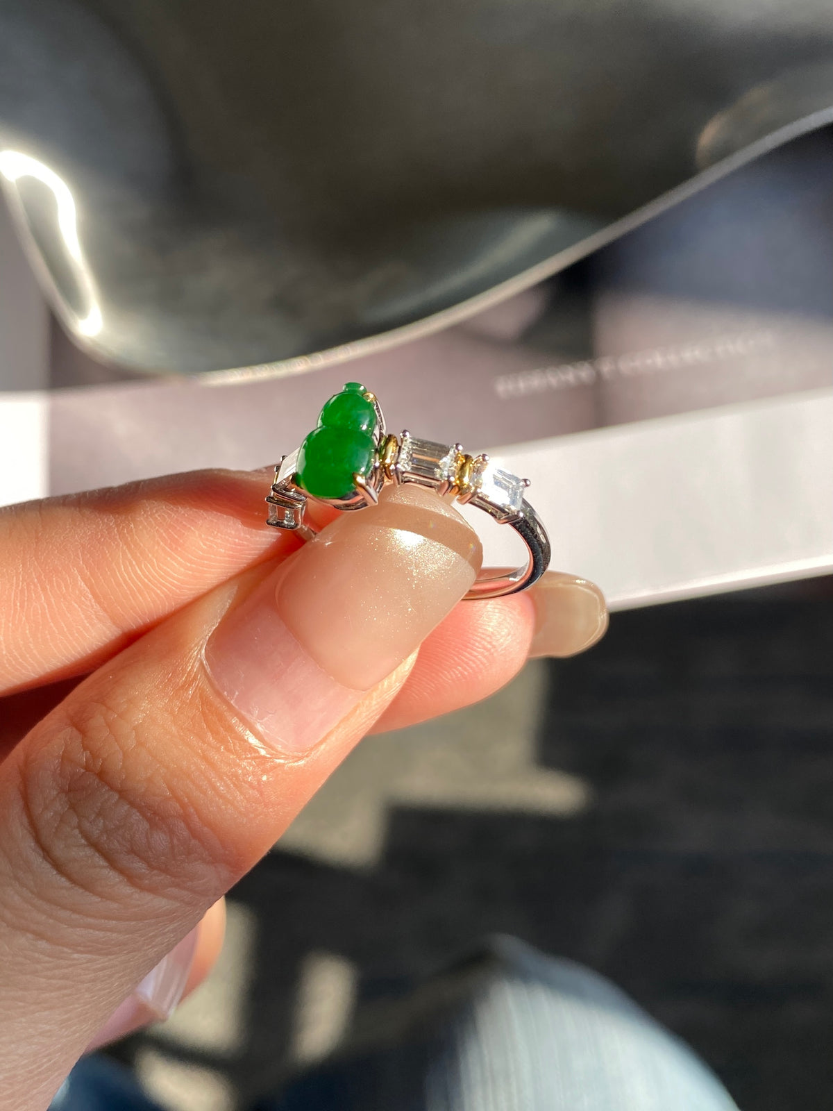Green gourd jadeite ring with openwork band and clear baguette stones