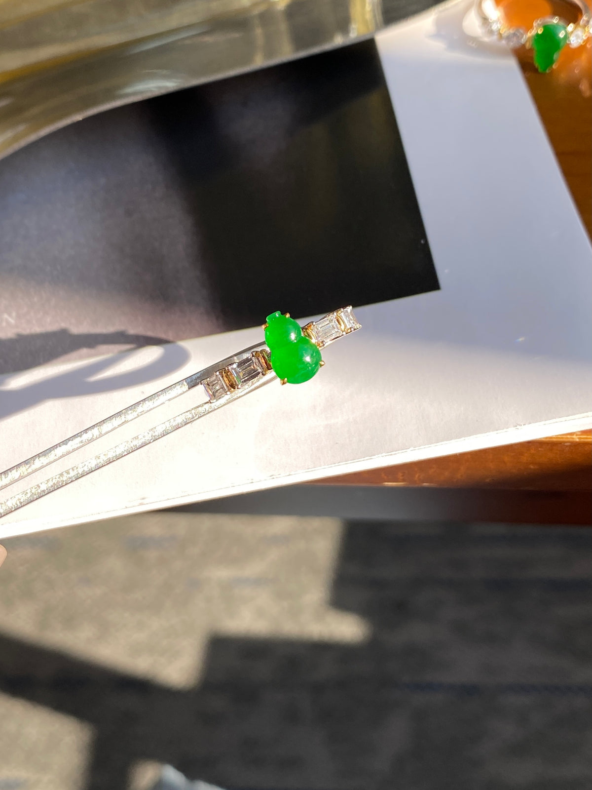 Green jadeite gourd ring with baguette crystal accents, gold-tone band
