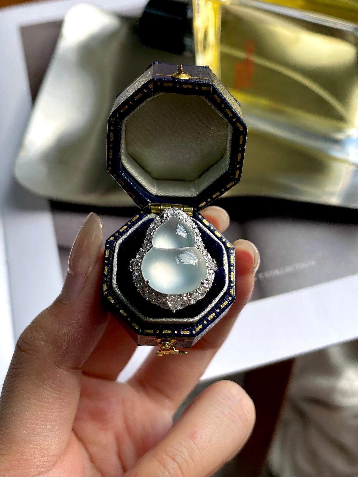 Silver-tone gourd ring with oval white jade cabochon and halo stones
