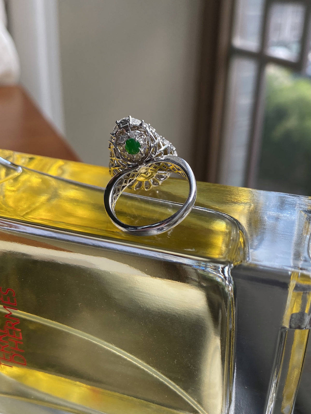 Silver-tone ring stack with green gemstone top and white halo stones