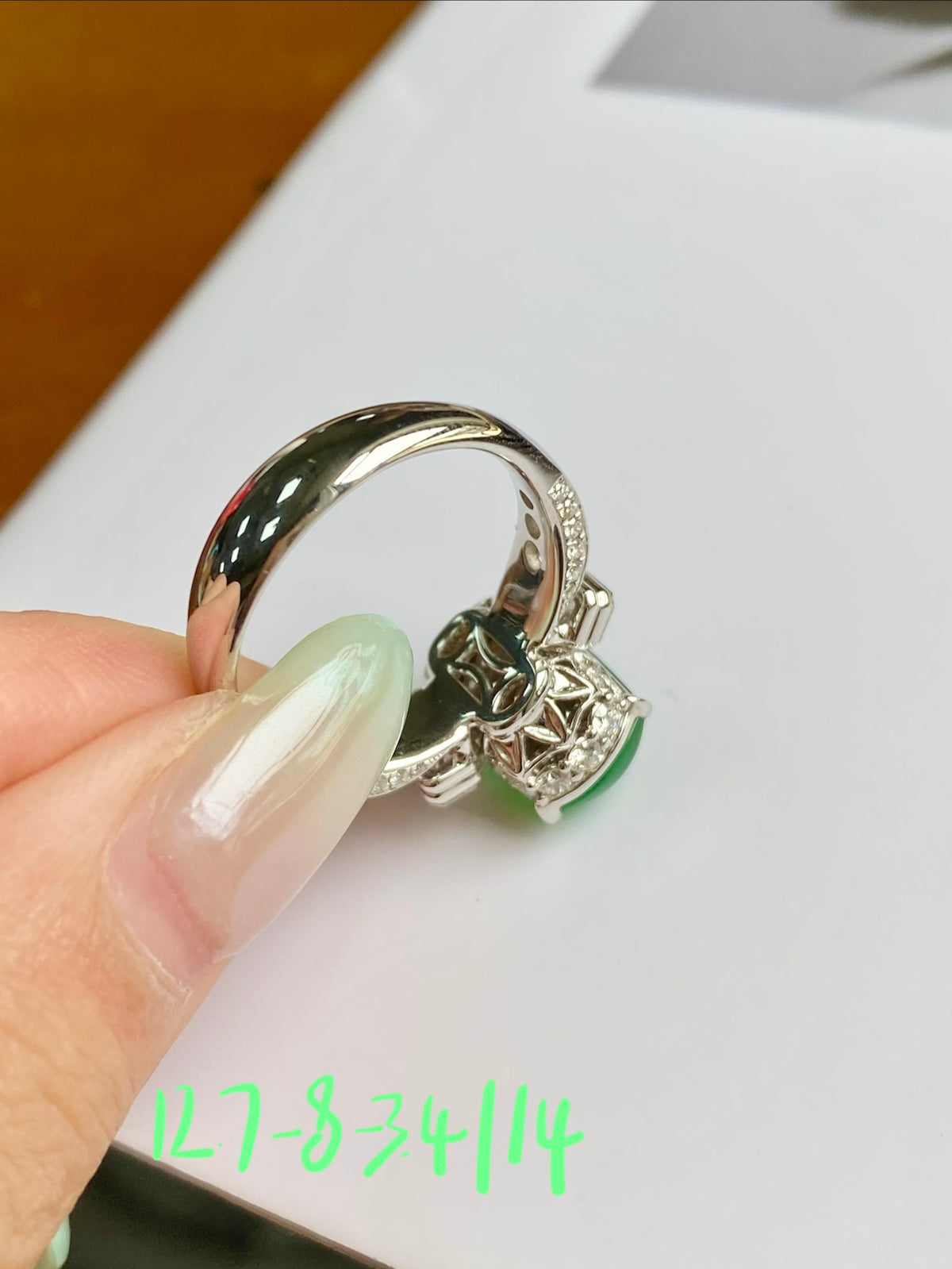 Silver jadeite tablet ring with green center stone and baguette diamond frame