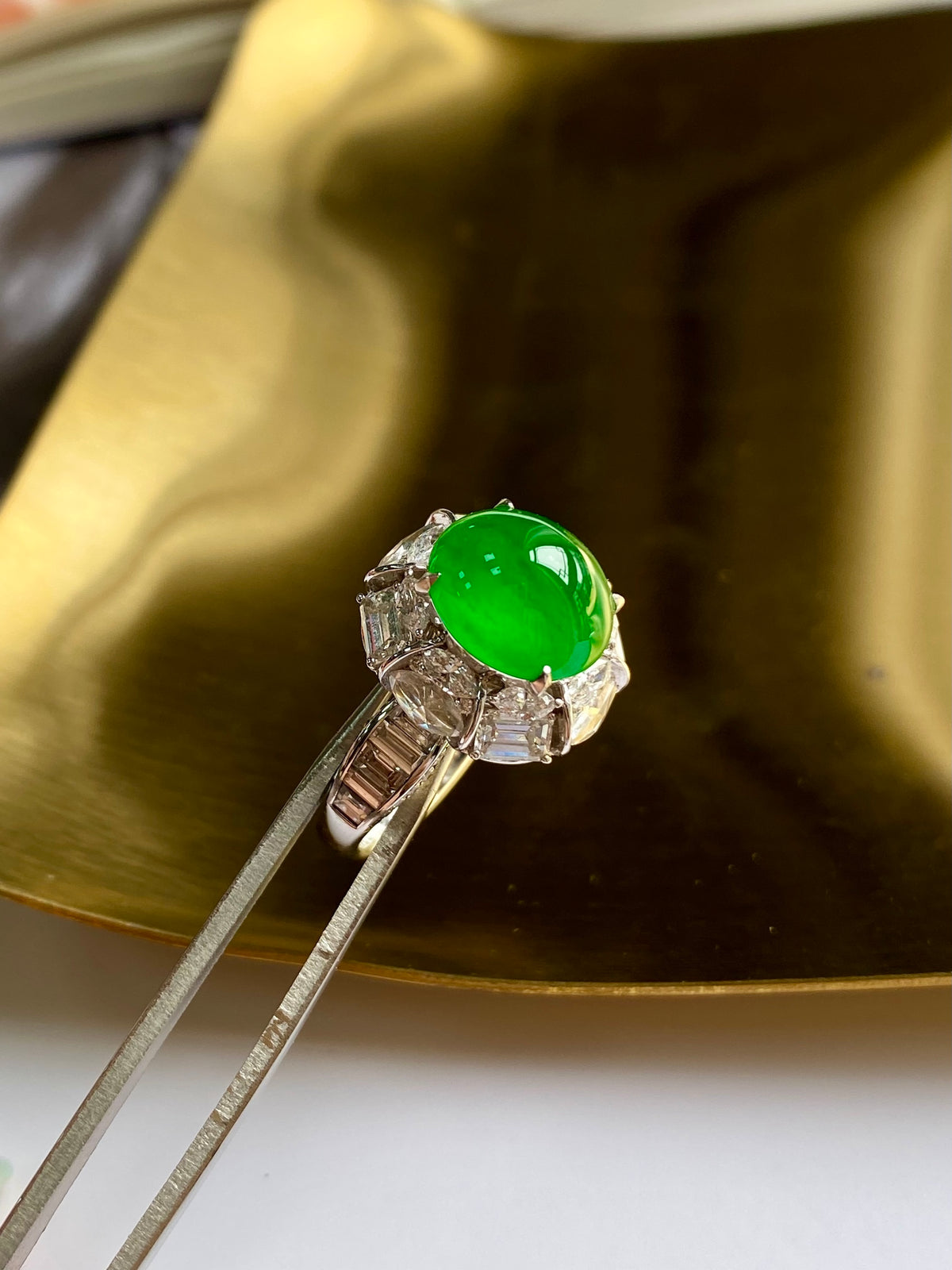 Green jade cabochon ring showing cathedral-style band and square side stones