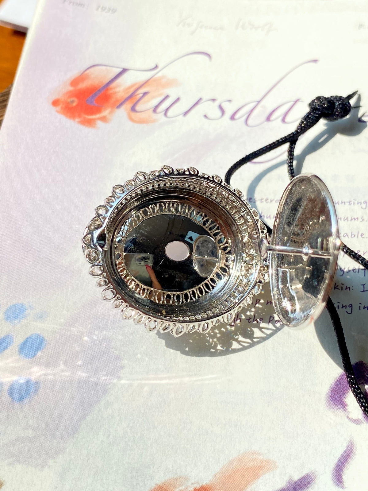 Diamond-like pendant setting with large oval cabochon, on black cord