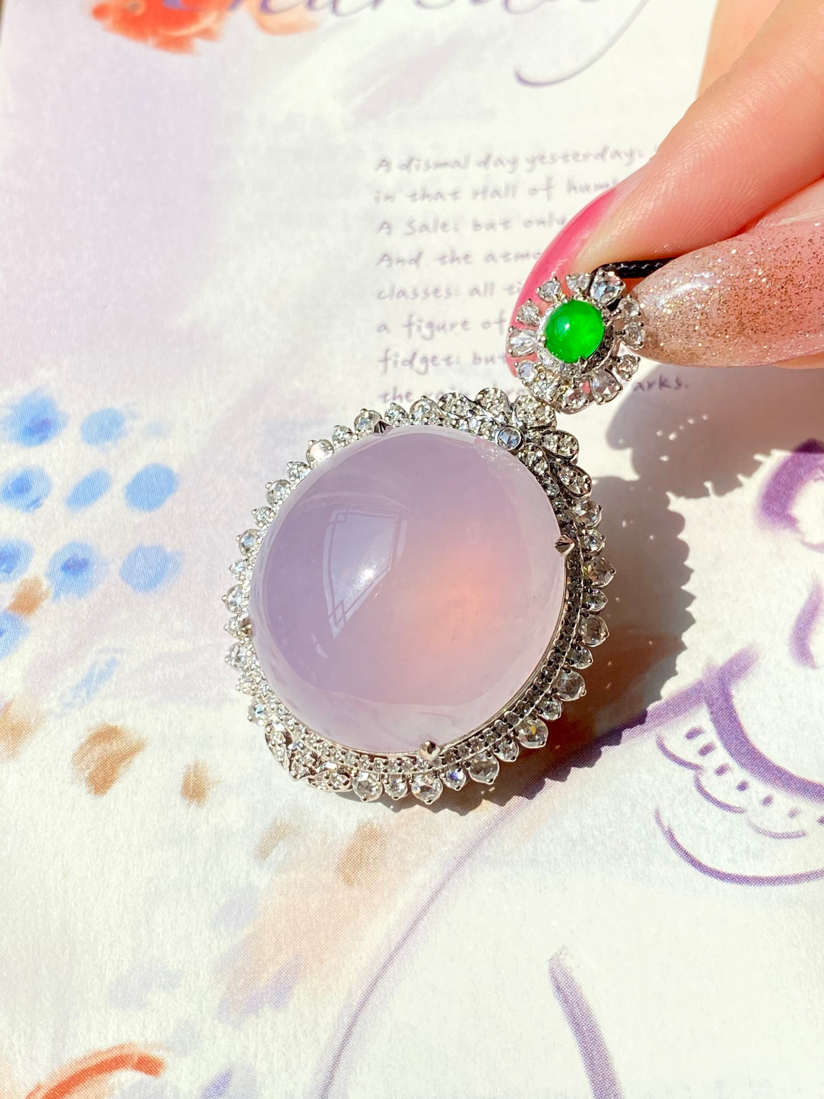 Lavender oval pendant with green round top stone and glittering halo on black cord