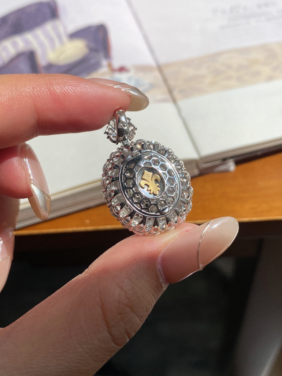 Round medallion pendant with patterned edge and gold-tone center on chain