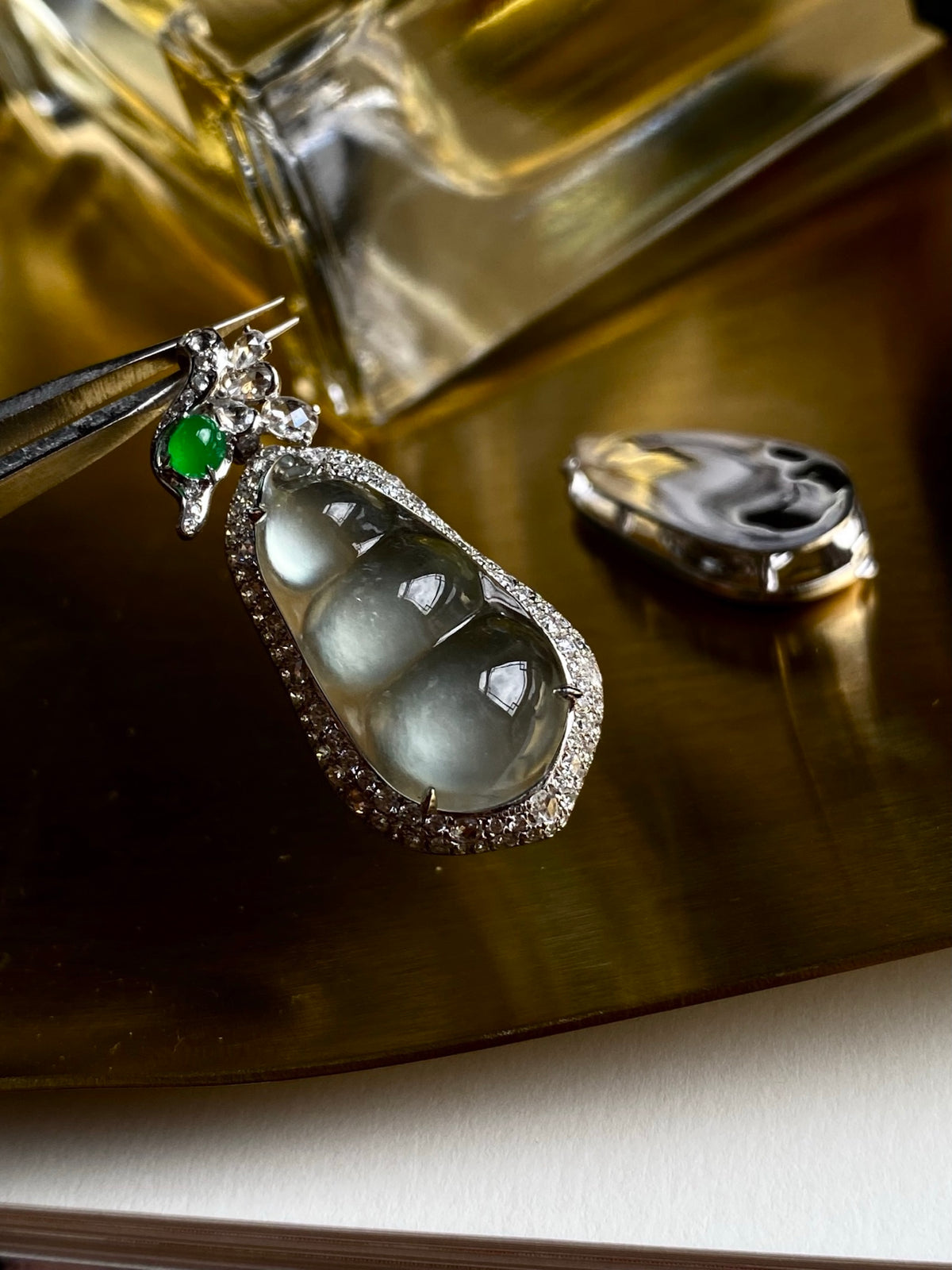 Sparkling silver jadeite bean pendant with green top stone and teardrop bezel