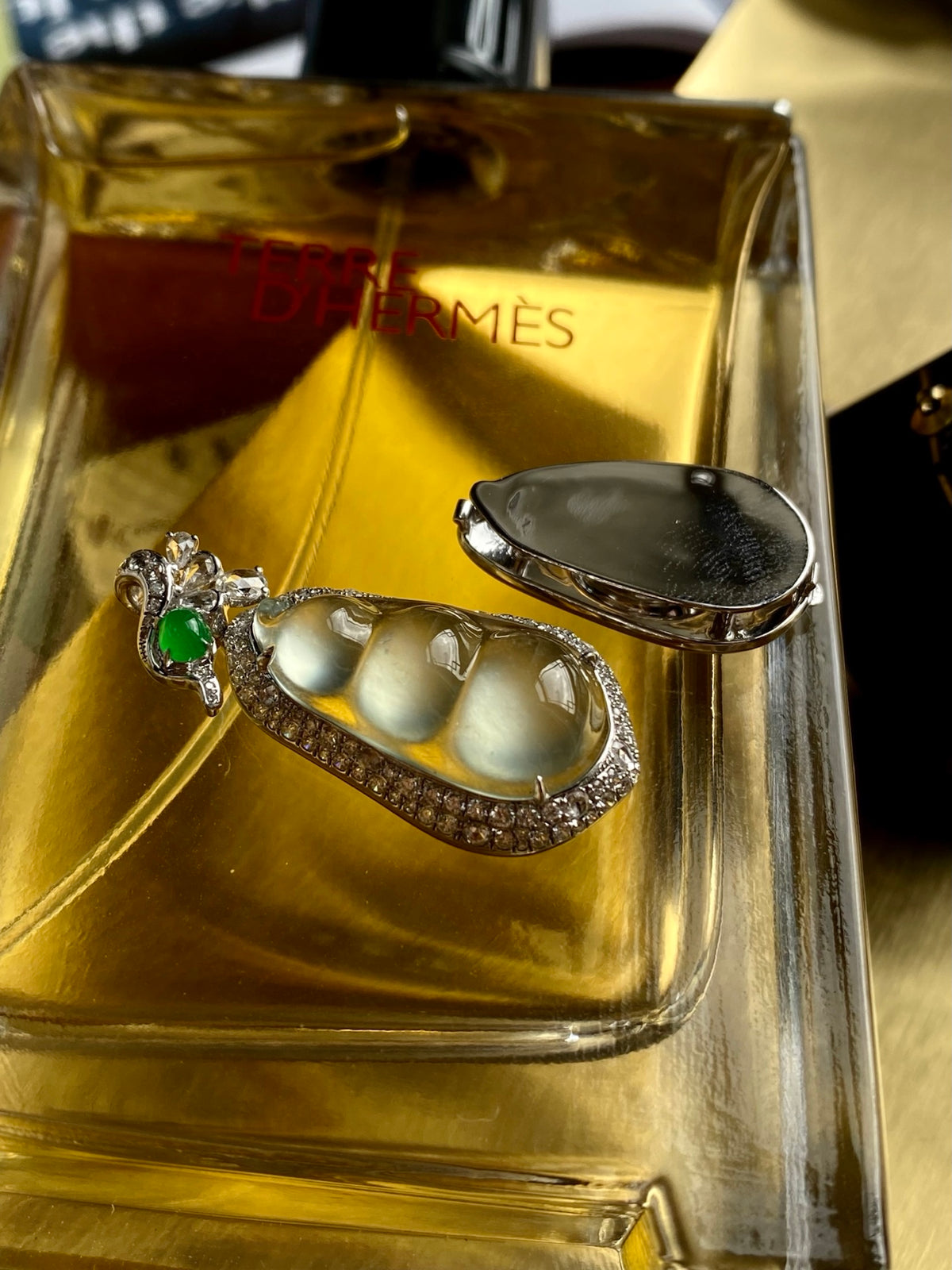Jadeite bean pendant in silver with green top stone and sparkling border