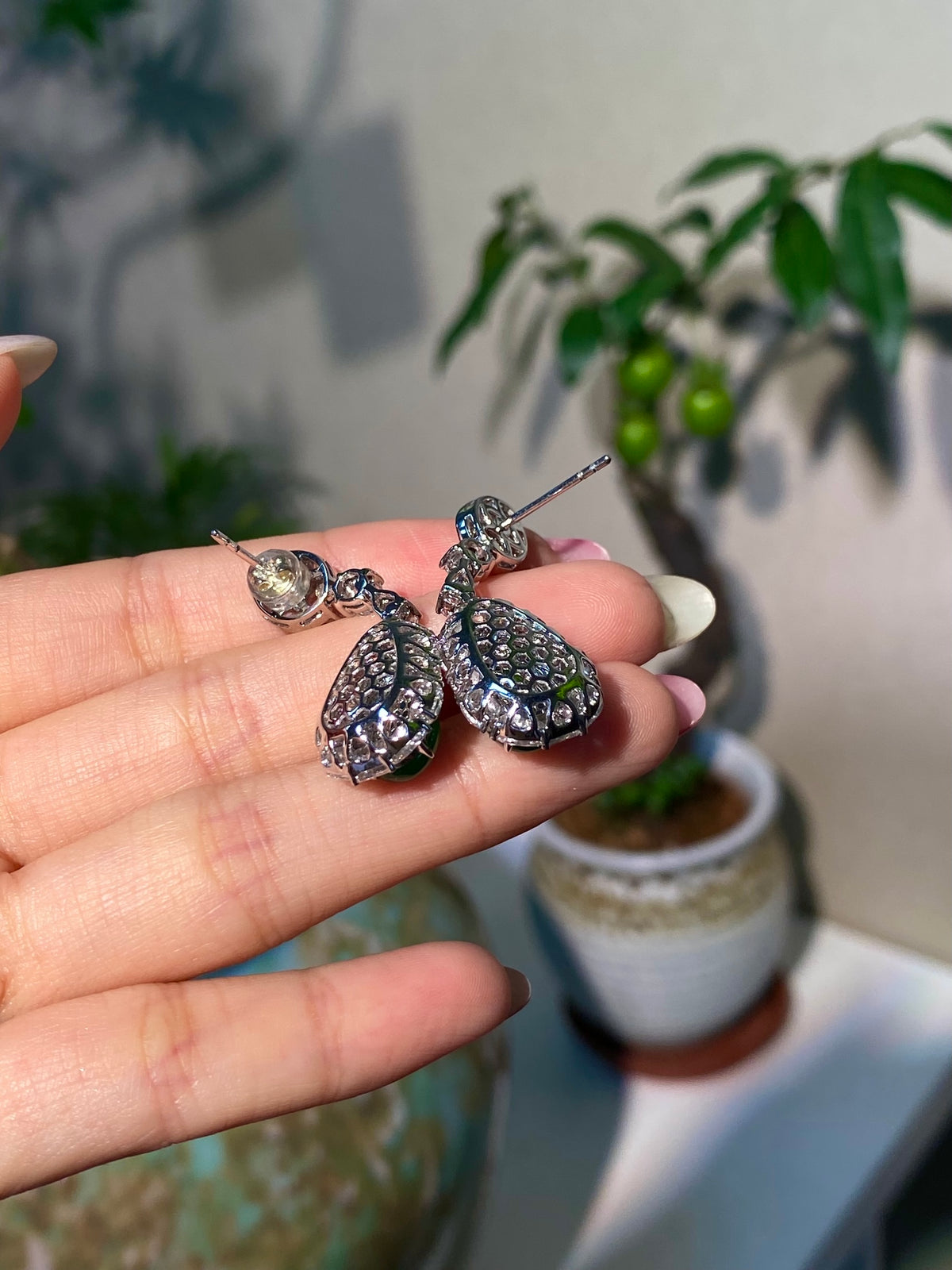 Dangling jade gourd earrings with glittery teardrop settings and metal hooks