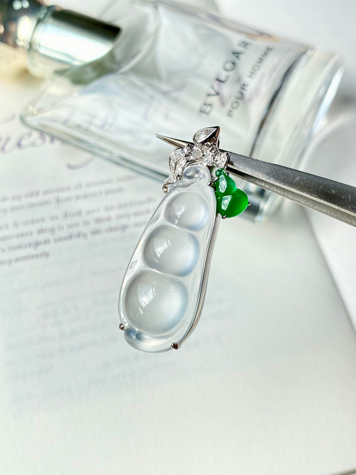 Silver-tone teardrop jadeite bean pendant with diamond-like accents and small green charm