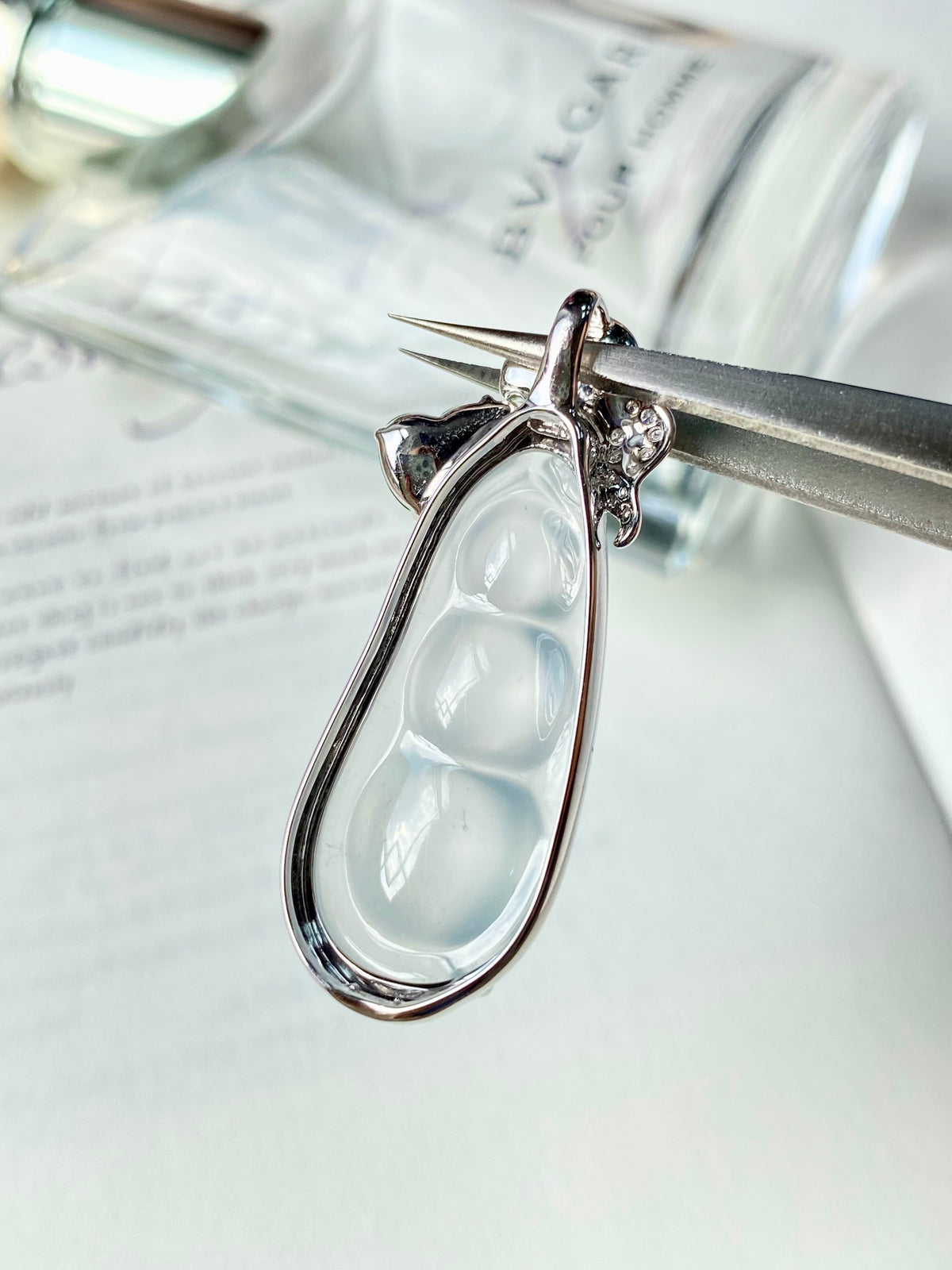 Silver-tone jadeite bean pendant with arched setting and diamond-like star detail