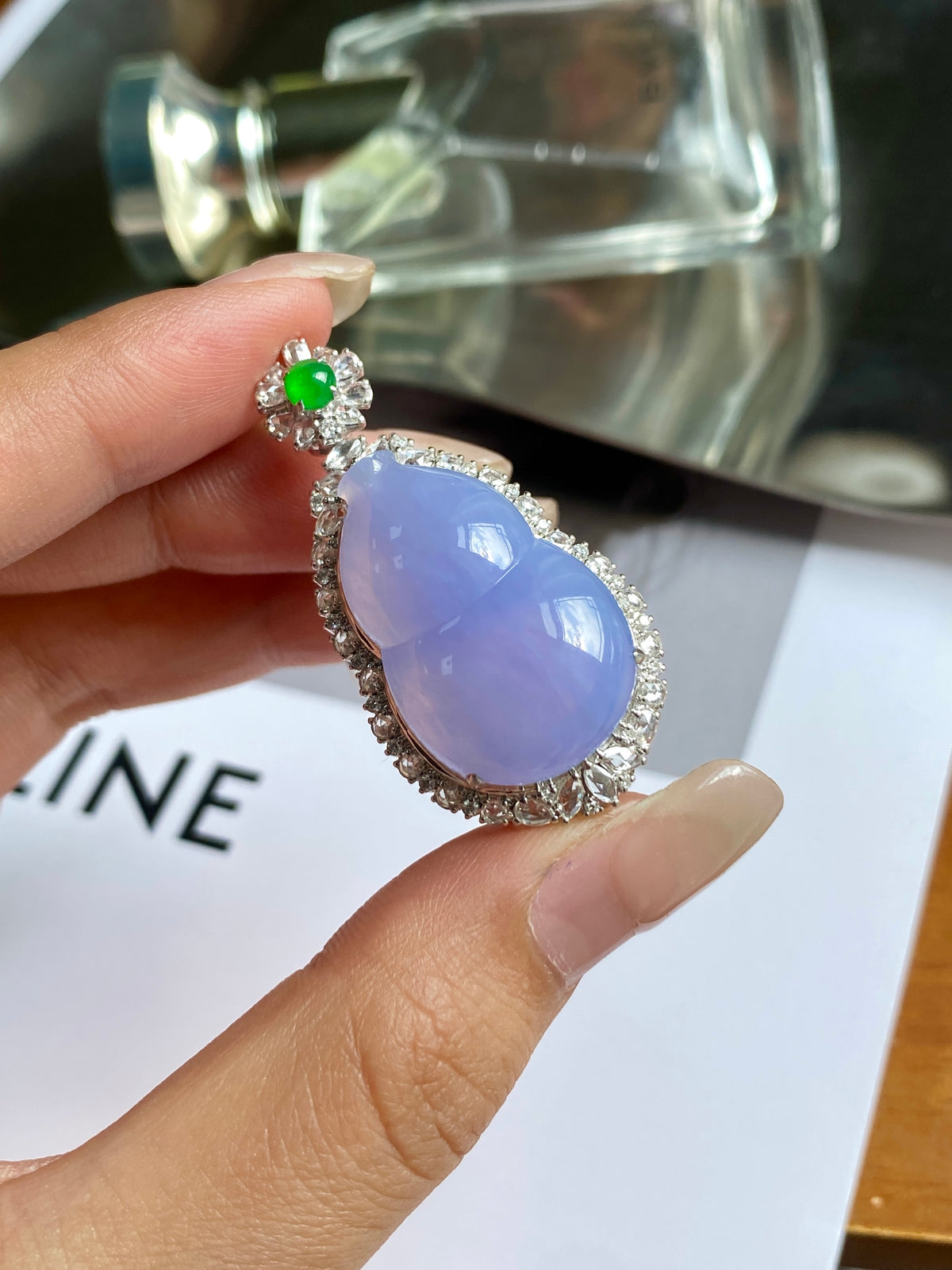 Lavender teardrop pendant in silver with green flower bail and rhinestone border
