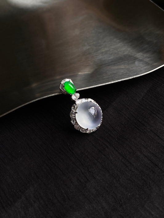 Icy white jadeite cabochon pendant with green stone and halo setting