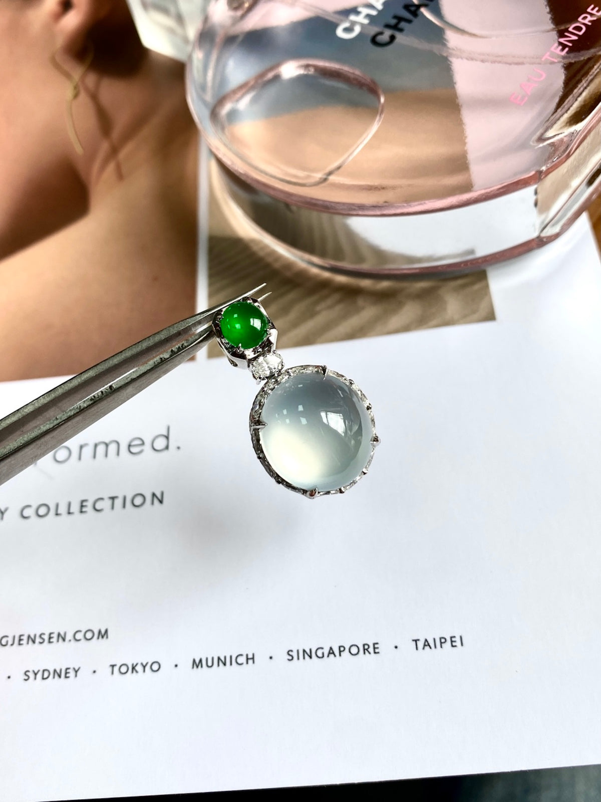 Jadeite cabochon pendant with green round stone and white oval stone in silver bezel