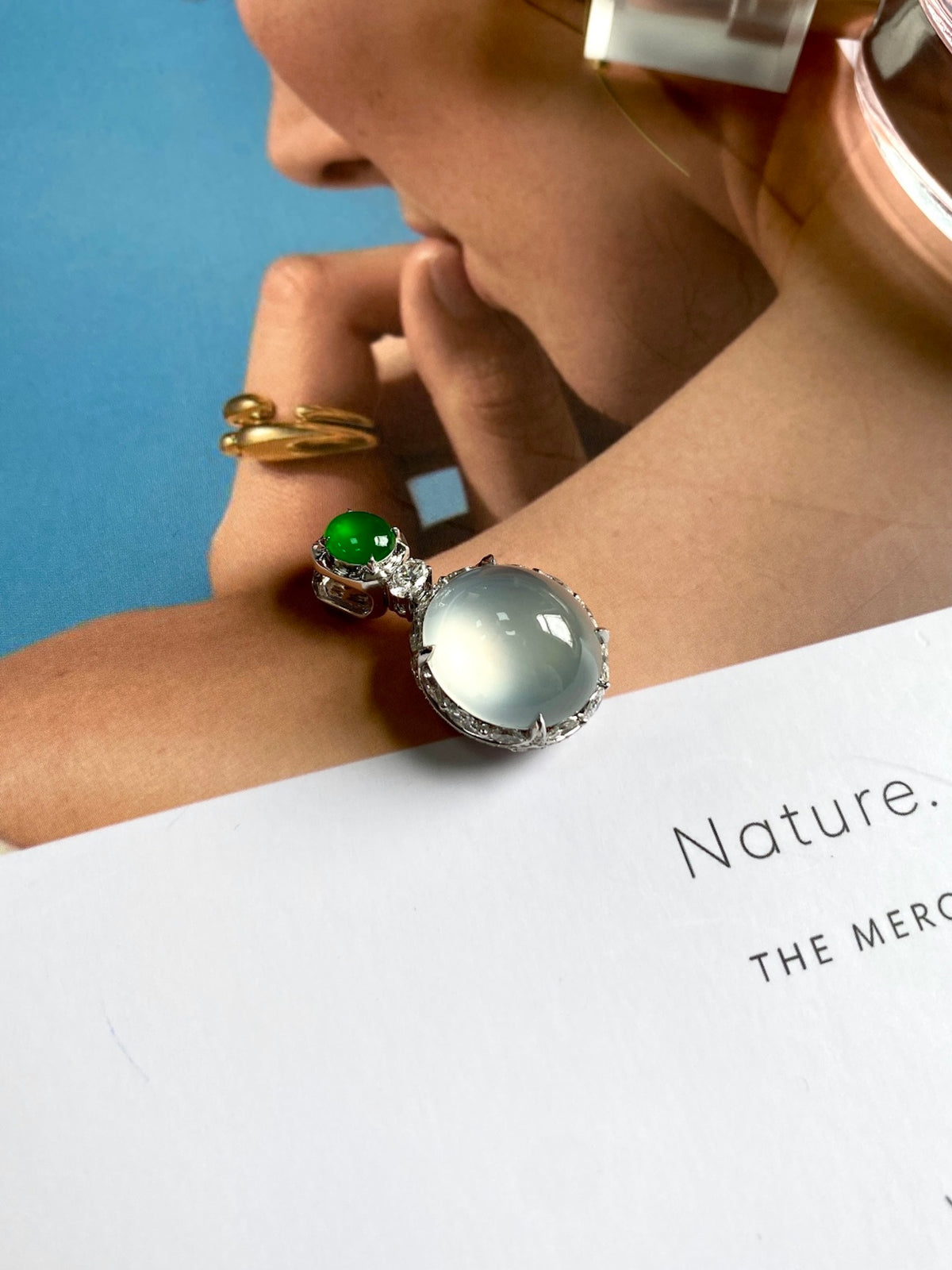 Jadeite cabochon pendant on chain with green round stone and large white oval stone