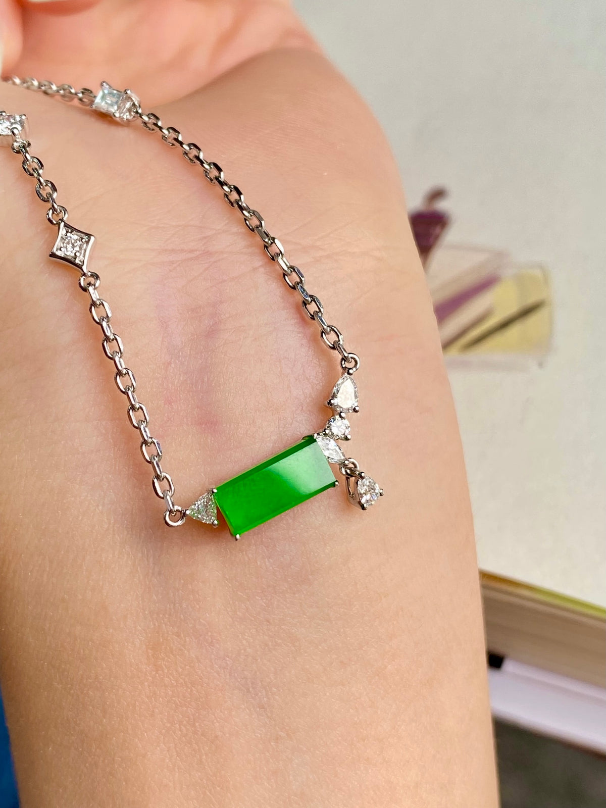 Green jadeite tablet bracelet on wrist, silver chain with sparkle accents