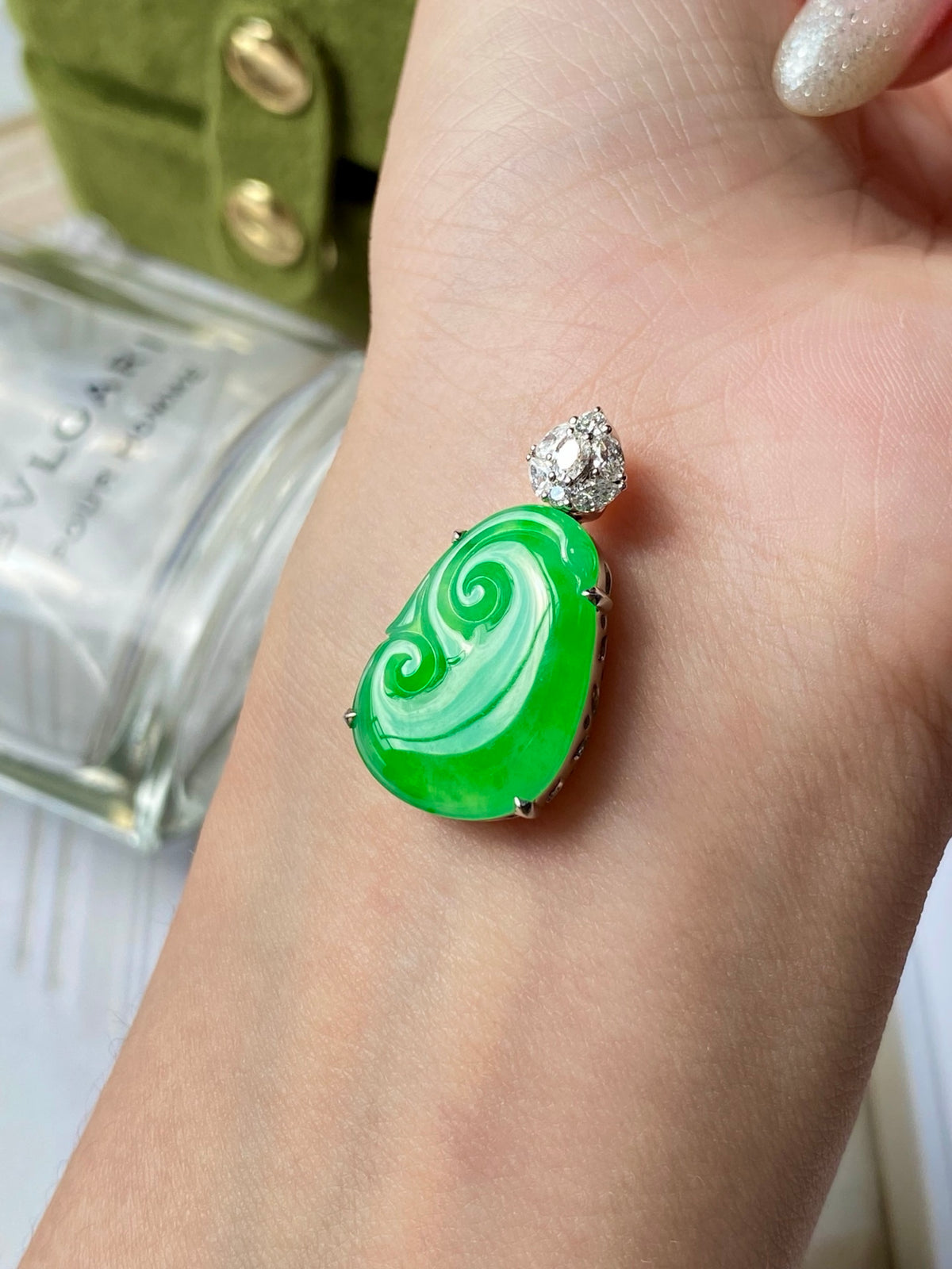 Green ruyi jadeite pendant with diamond-like stud above, worn on finger