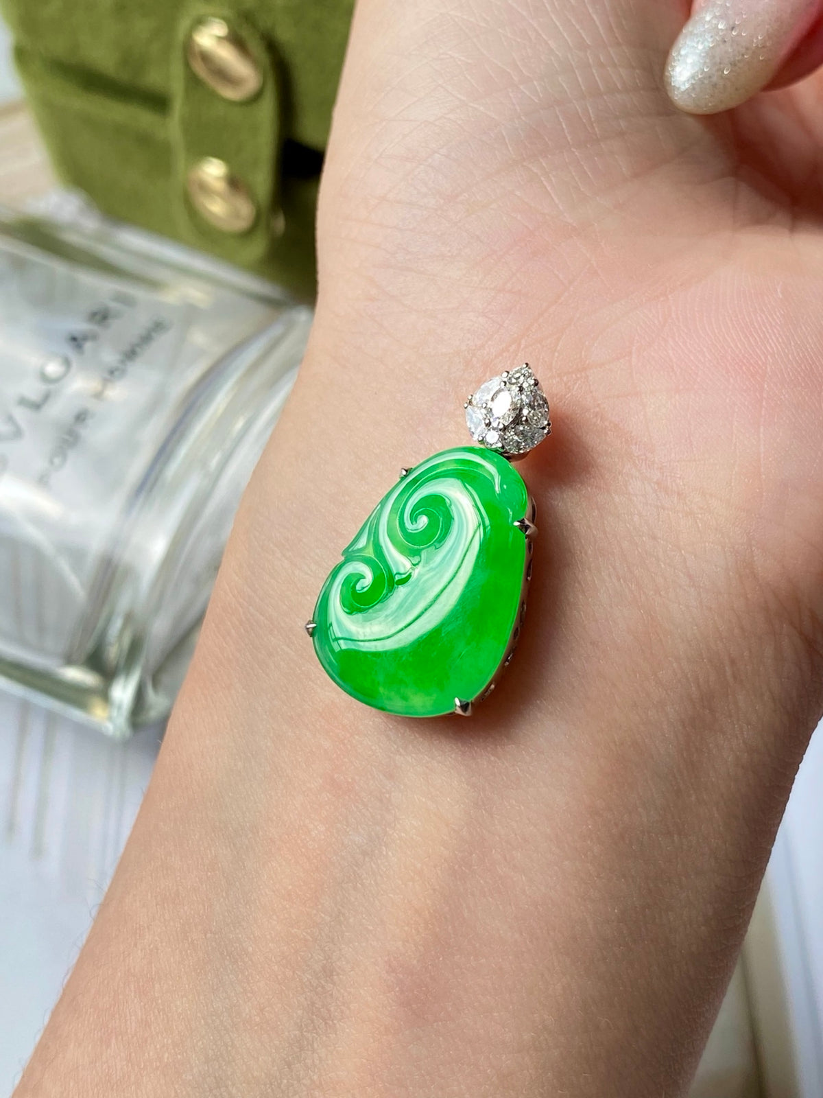 Green jadeite ruyi pendant with diamond-like top stud, close-up on finger