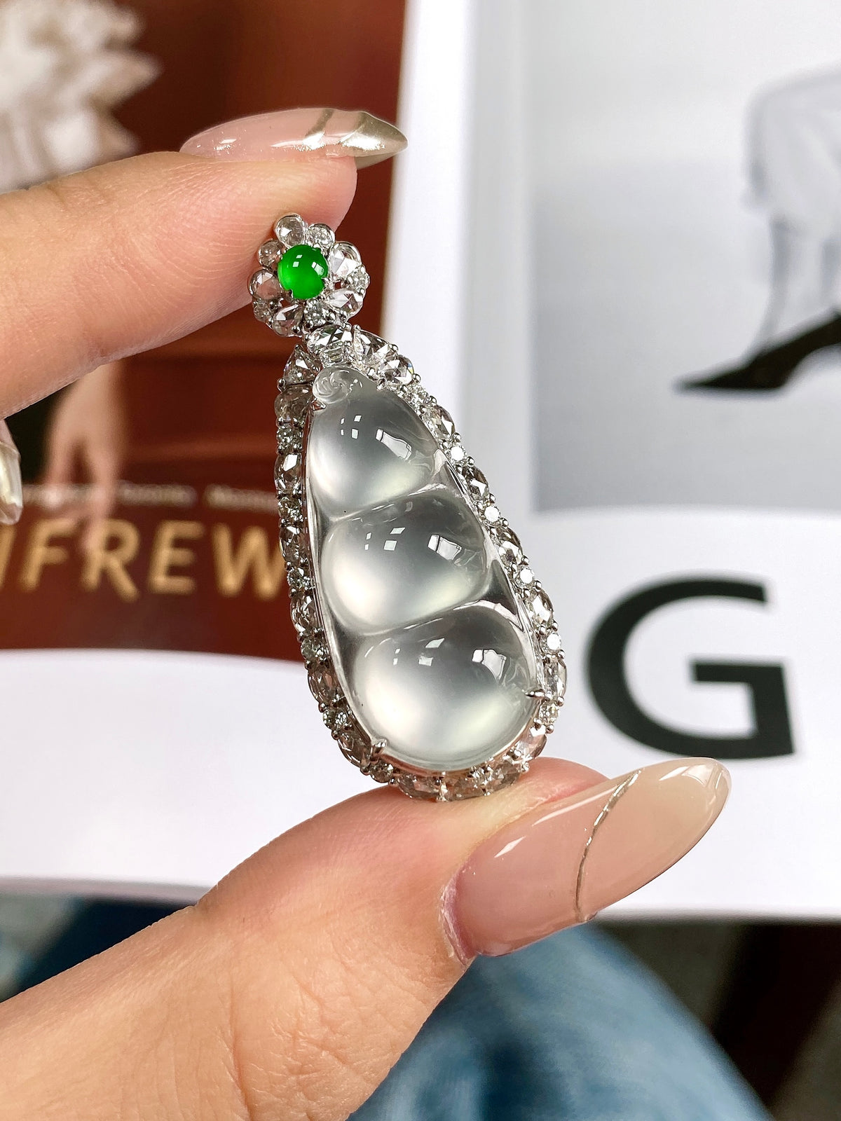 Teardrop bean pendant in silver with green center stone and sparkling crystal border