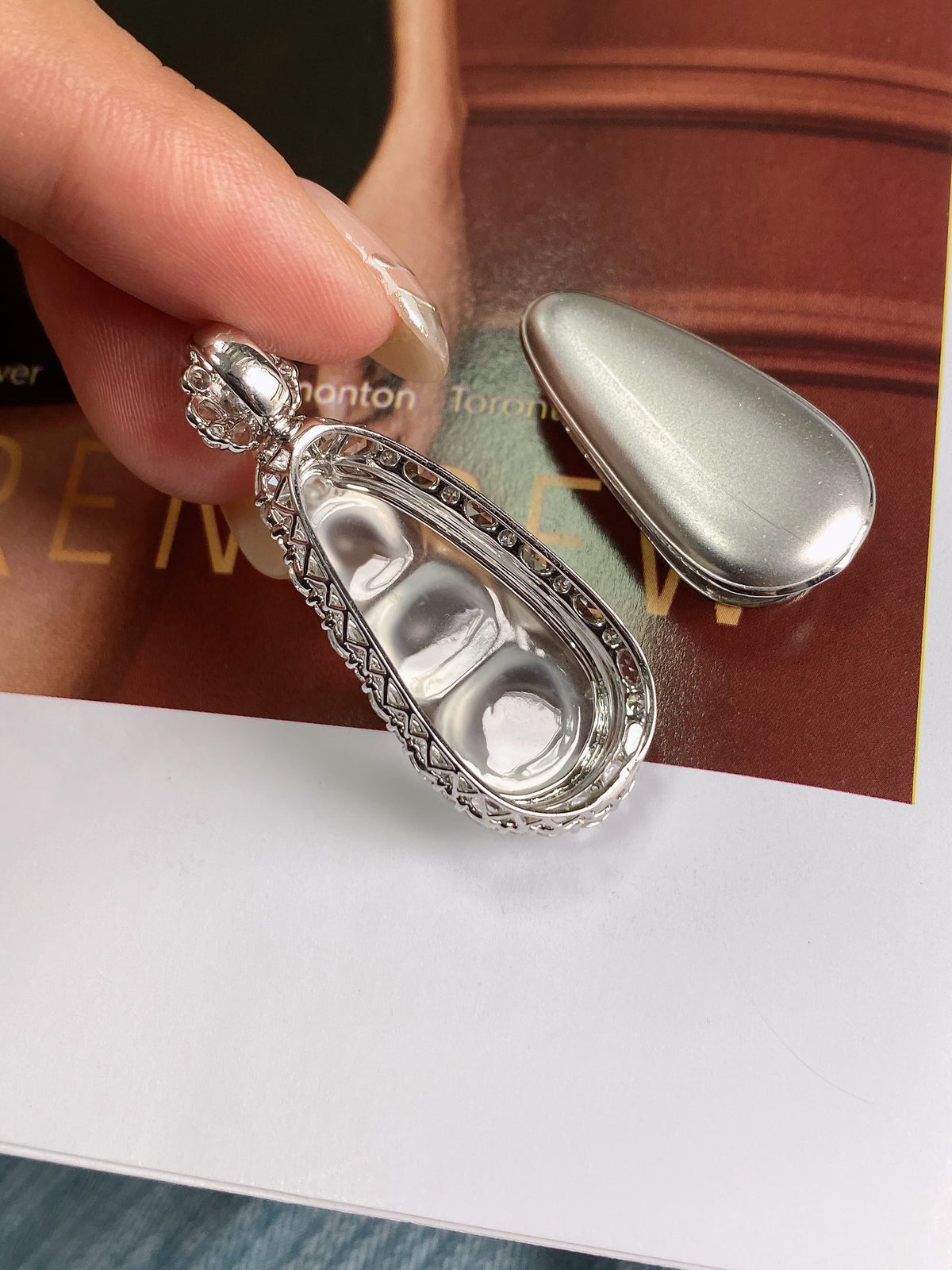 Back of silver bean pendant with oval setting and small crystal trim