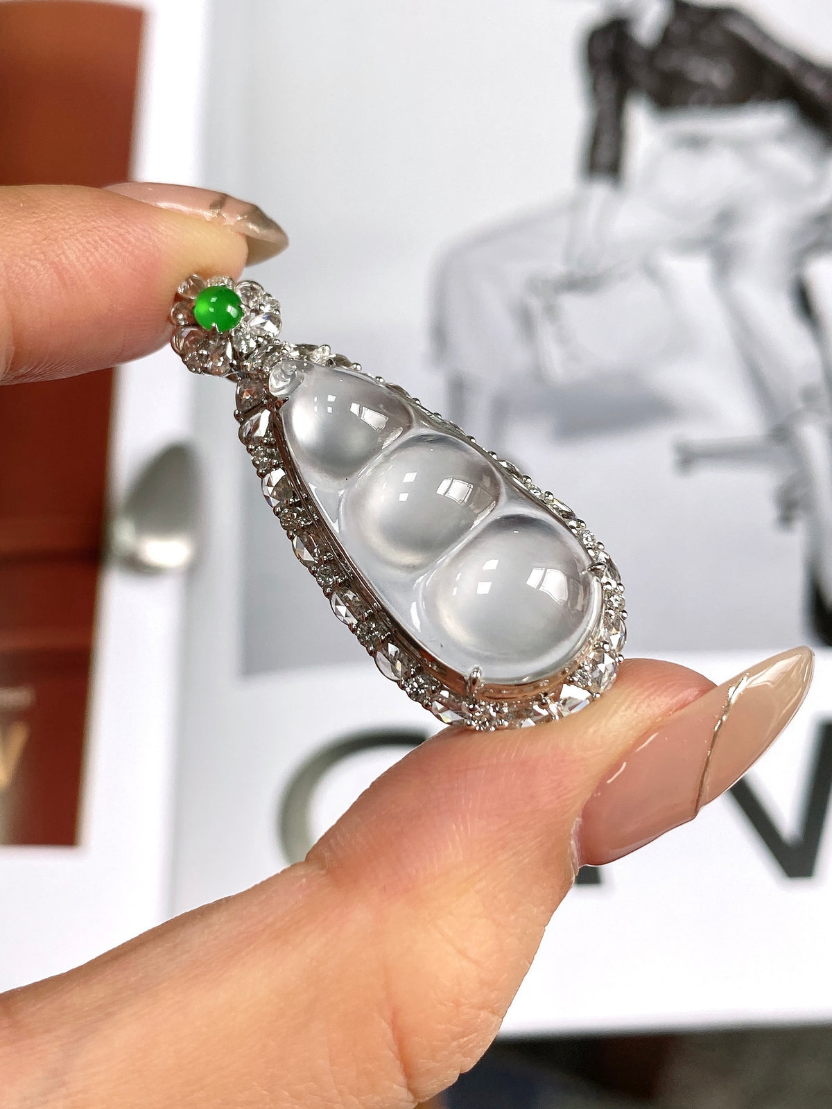 Bean pendant with green jadeite top and three white teardrop stones in silver bezel