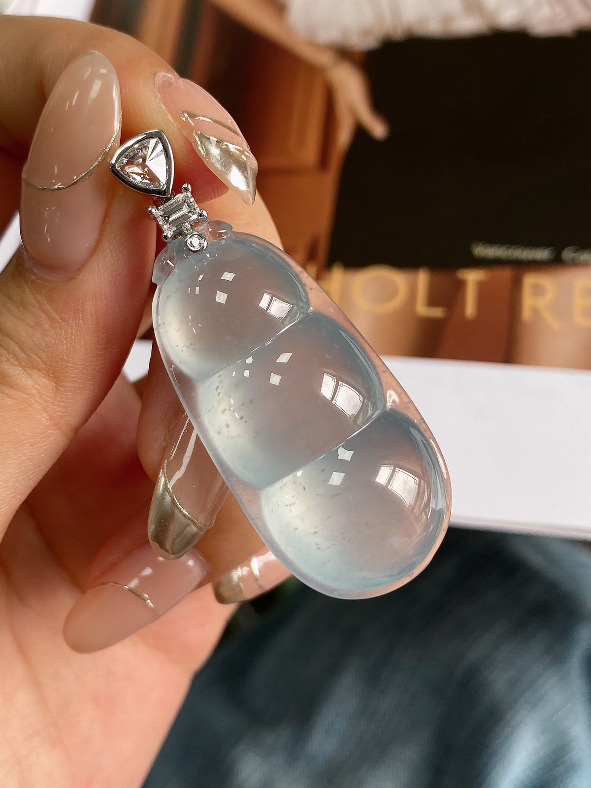Sky-blue jadeite bean pendant with silver-tone bail and crystal-stud charm