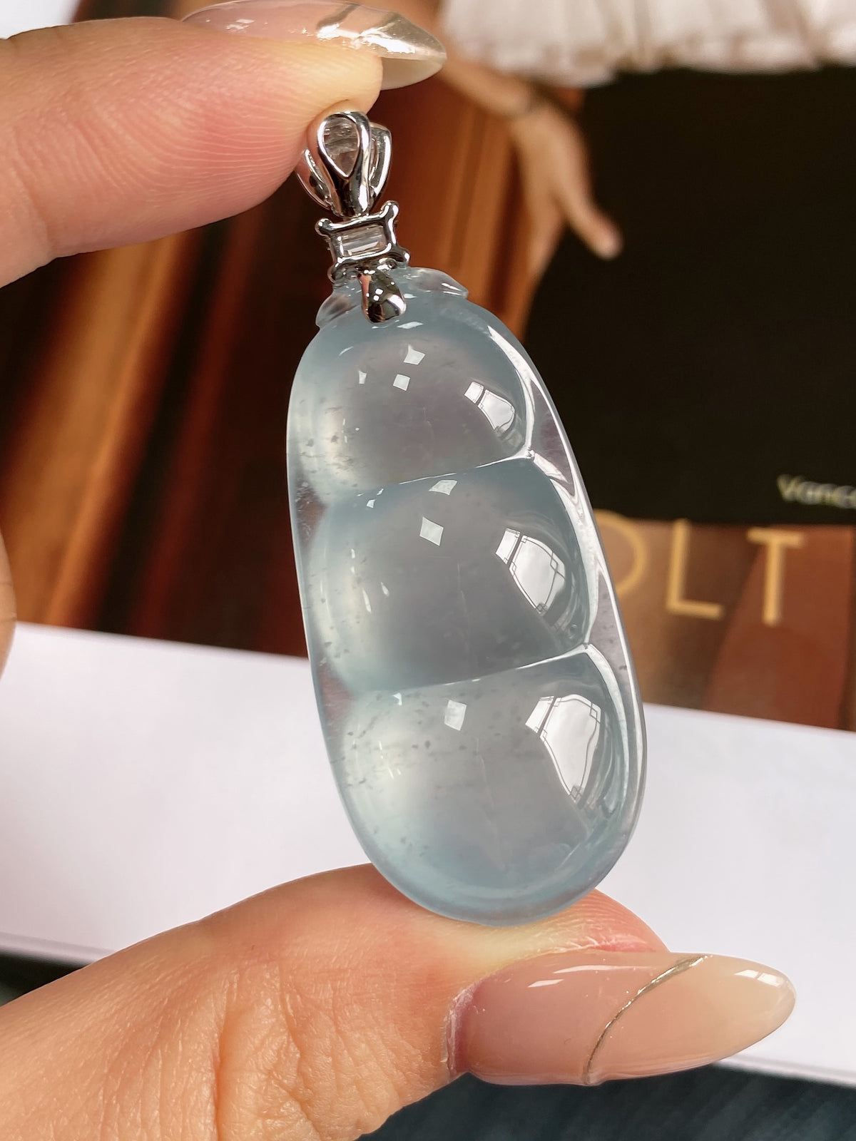 Sky-blue jadeite bean pendant with silver-tone top setting and hanging loop