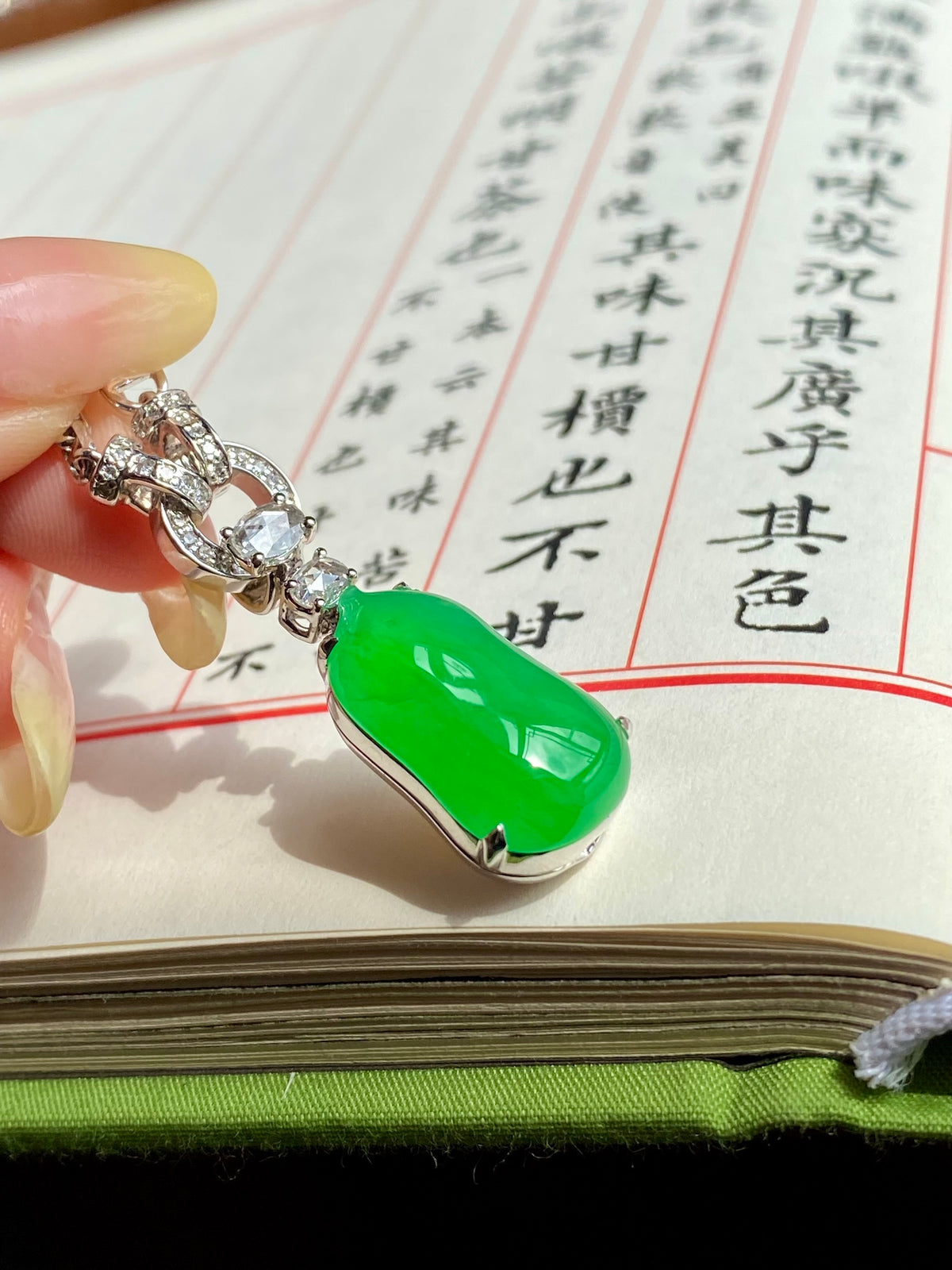 Green jadeite melon pendant with silver-toned rhinestone chain links