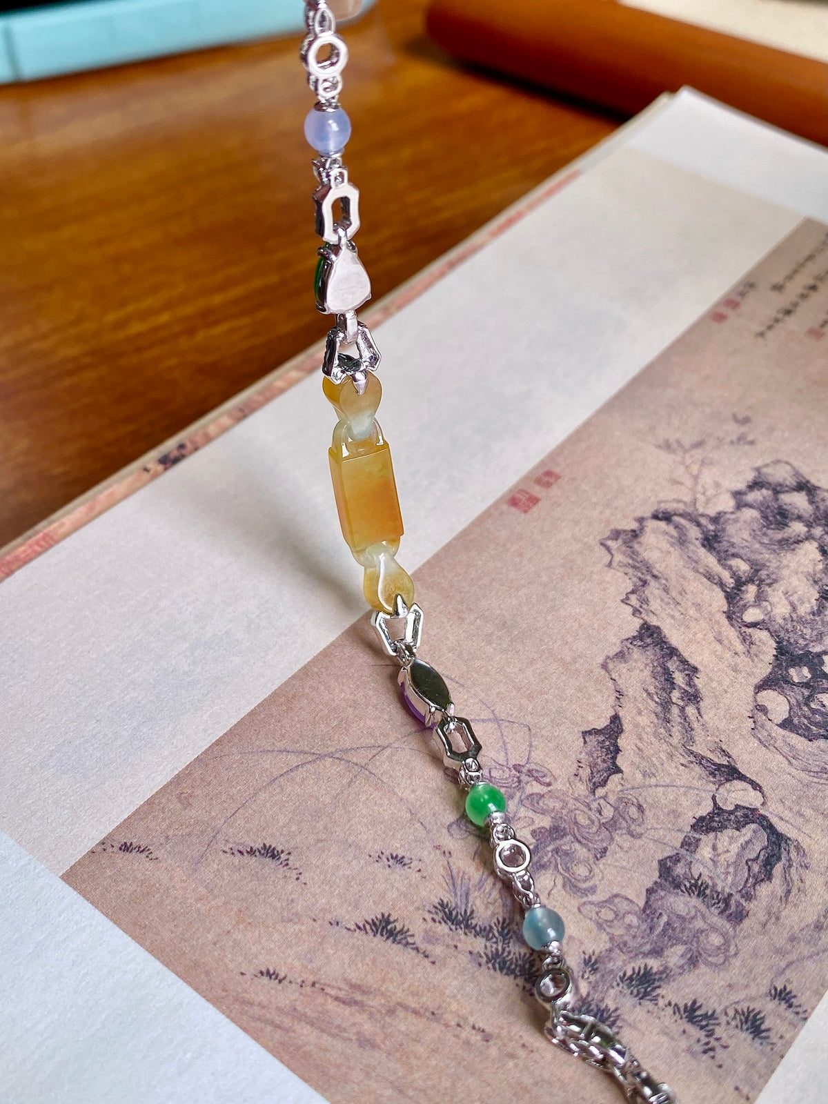 Yellow jadeite bead bracelet with silver links and green, purple, orange bead drops