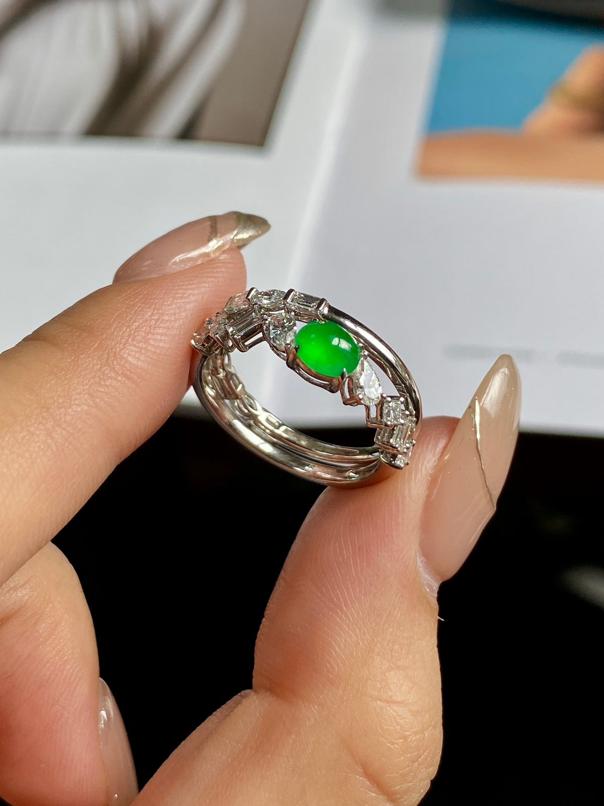 Stackable ring showing green oval cabochon with clear stone prong details