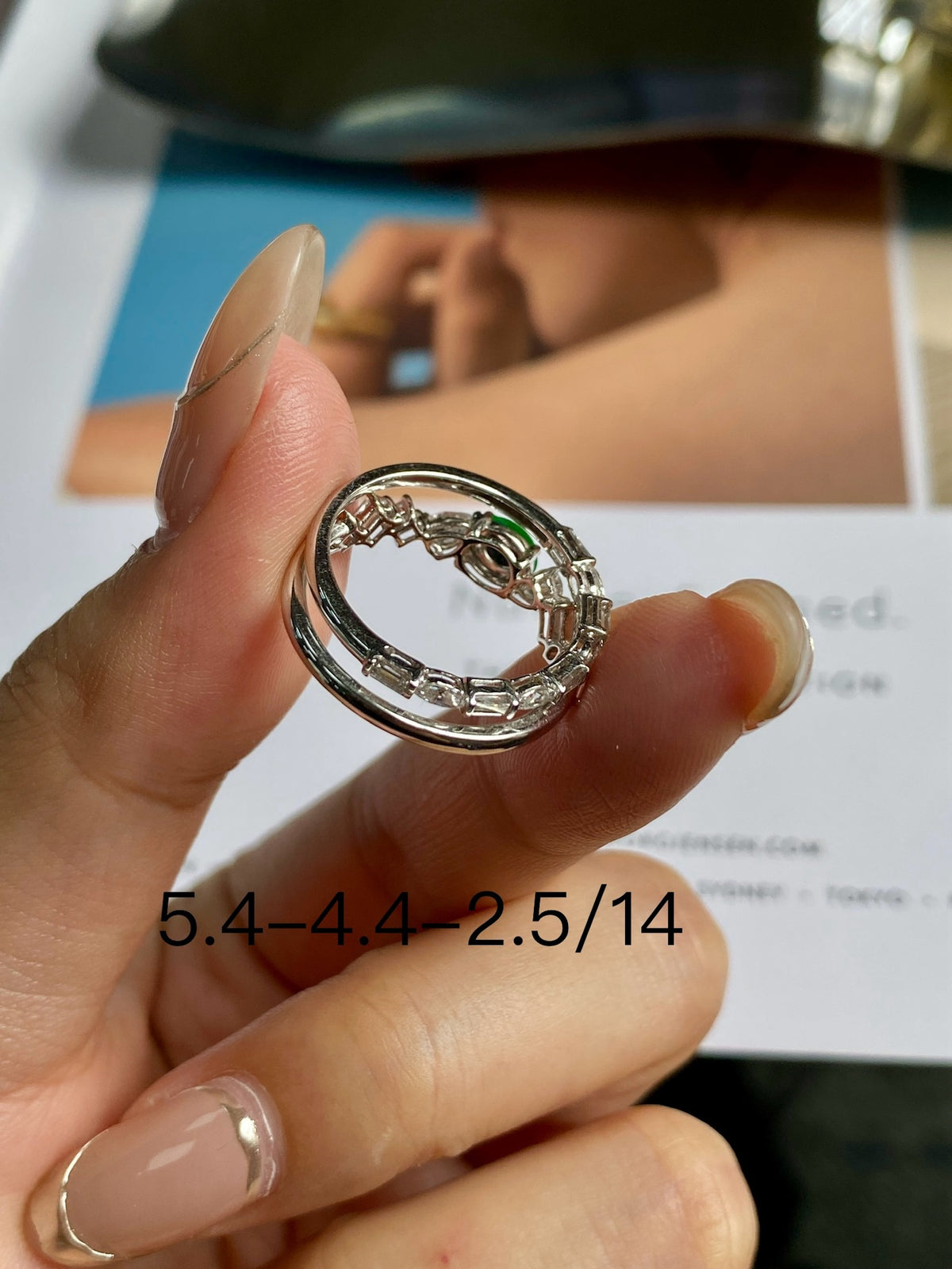 Stackable ring band view with green cabochon and glittering clear stones