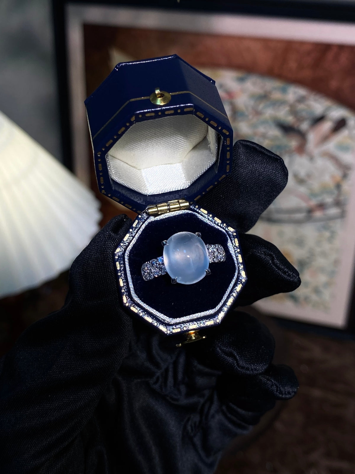 Light-blue cabochon ring, silver-toned setting with sparkling side stones