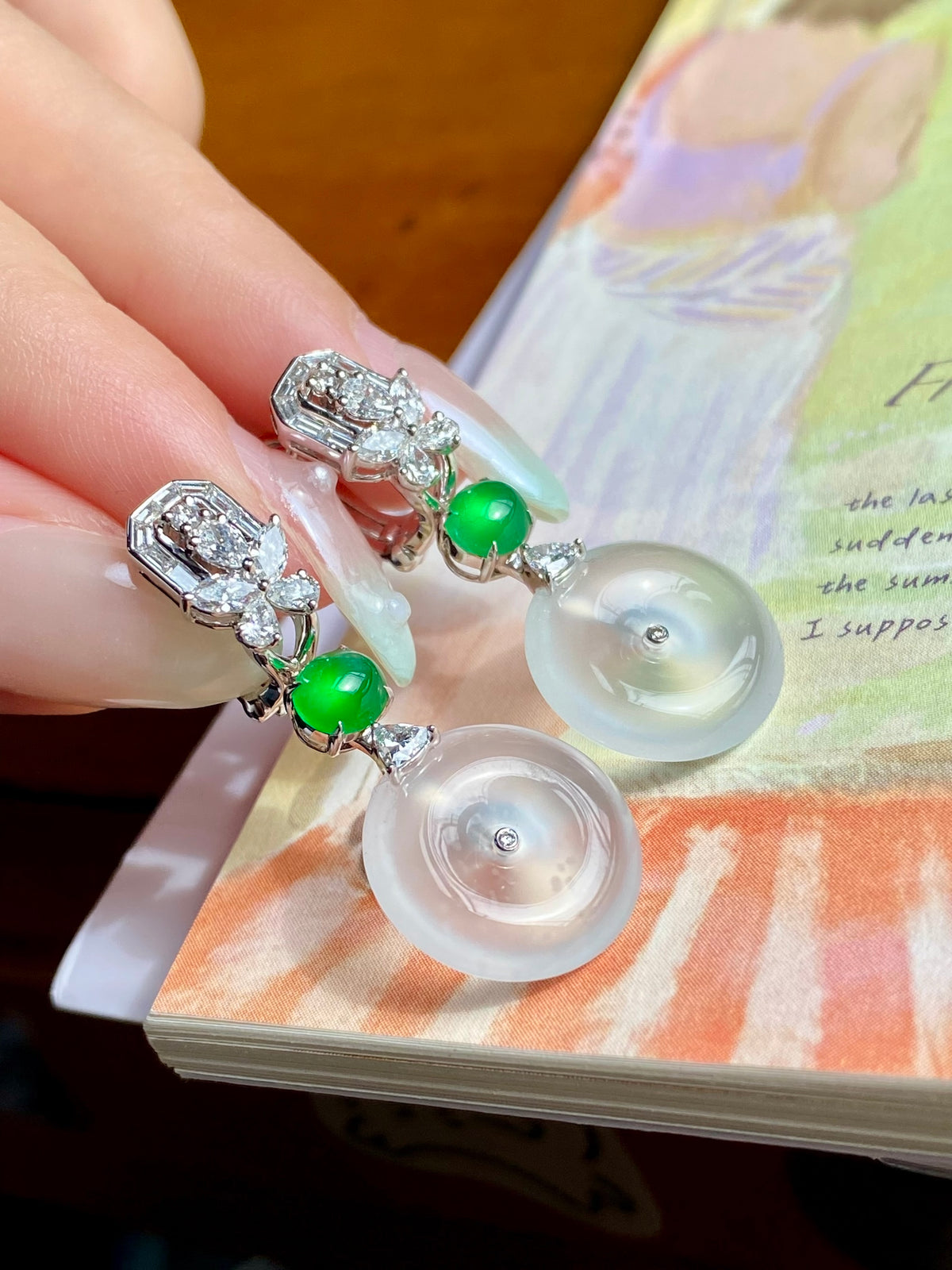 Silver drop earrings with white donut discs, green beads, and baguette crystal clusters