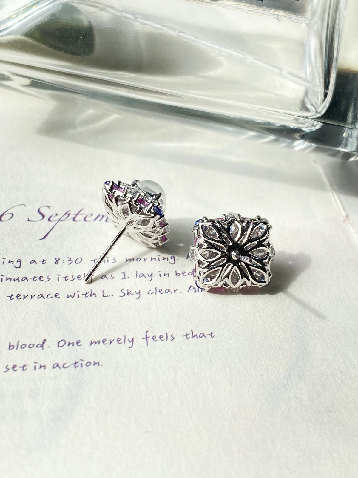 Silver-tone stud earring with floral back detail